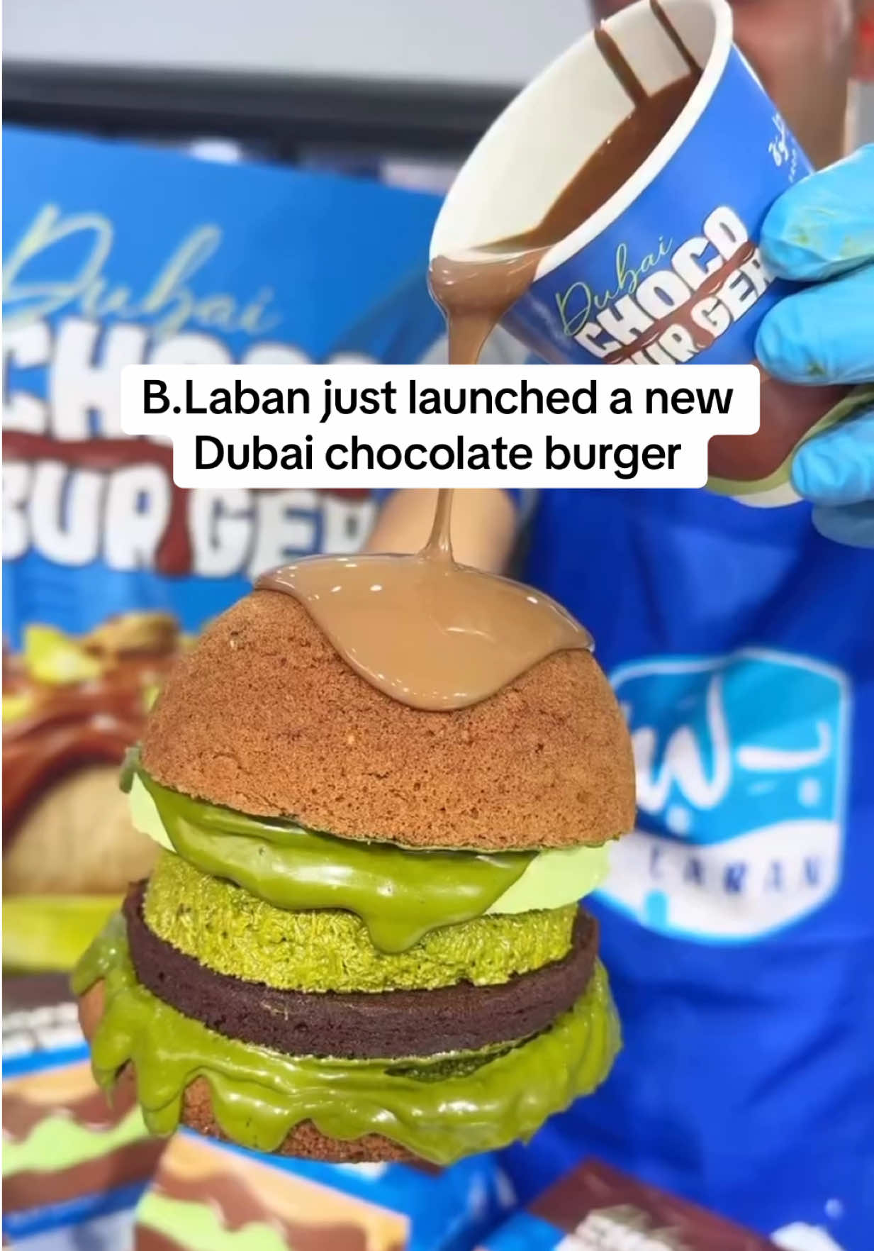 Is this the sweetest burger?  B.Laban just launched a new Choco Burger, made with soft English cake, Belgian chocolate brownies, pistachio mousse and crunchy pistachio kunafa, all drenched in chocolate sauce. It even comes with a cup of melted chocolate on the side. Would you try this? #dubai #dubaichocolate 