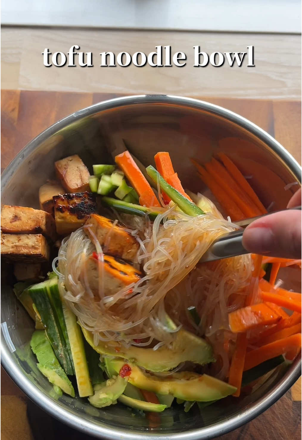 Tofu noodle bowl I eat on repeat 🔁 🍲 Start with your vermicelli noodles (soaked in boiling water for 10 minutes and drained)  Add carrot, cucumber, avocado and tofu to the noodles.  Add in your sauce (soy sauce, sweet chilli, rice vinegar, garlic & teriyaki sauce)  Enjoy!!  (I measure with the heart so feel free to do the same 🤭)  #vegan #tofu #EasyRecipe #DinnerIdeas #veganfood 