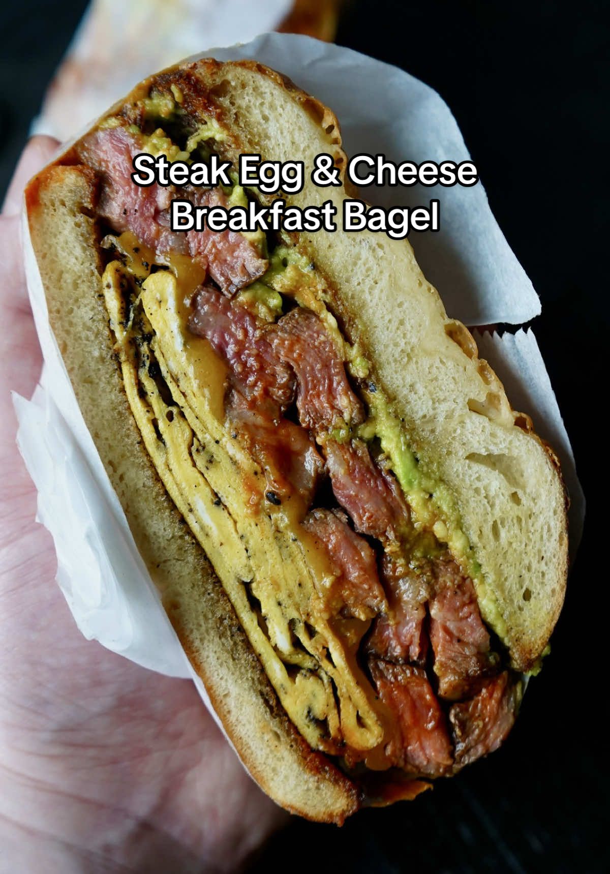 Steak Egg & Cheese Breakfast Bagel 🥩🔥 Absolutely banging... could eat this every day! FULL RECIPE ⬇️ INGREDIENTS - Asiago bagel  - Extra virgin olive oil  - ~16 oz bone-in ribeye  - Seasonings: Salt, pepper & garlic powder  - 3 eggs - Cheddar cheese - Avocado  - EBTB seasoning  - Truff Sauce  DIRECTIONS  1.  Pat the steak dry, coat in olive oil then season both sides with salt, pepper and garlic powder.  2. Get a large skillet going over medium-high heat and add in 1-2 tbsp of ghee. Sear the steak for about ~3-4 min per side or until it reaches ~130° internal. Remove and let rest for ~10 min before slicing.  3. Toast your bagel in the steak residue. 4. Scramble up the eggs in a bowl the pour them in the skillet. Let the eggs cook over low heat until firm and cooked through then fold them into a square and top with cheese. 5. Add the avocado to a bowl, smash it up and season with EBTB seasoning. 6. Assemble your sandwich & ENJOY! 🙌🏻 • • • • #explore #cooking #steak #food #breakfast #EasyRecipe #foodporn