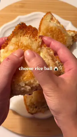 Cheese Onigiri 🧀🍙(Grilled Rice Ball) A crispy rice ball with melty cheese inside — and even more crispy cheese outside! Season rice with soy sauce and sesame oil, then shape into onigiri with cheese in the center. Pan-fry until golden, take it out, then add shredded cheese and black pepper to the pan. Place the onigiri on top and cook until the cheese turns crispy. Cheesy, crispy, and totally addictive! #onigiri #riceball #cheeselover #yakionigiri #EasyRecipe #japansesfood 