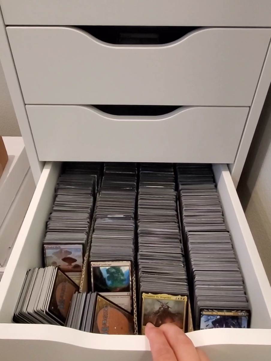 This IKEA organizer would make a great gift for the cardboard hoarding fanatic in your life 😅 Me? I'm just happy to have the hodge podge of boxes off the floor and the hubs is obsessed with the organization for his collection. WIN WIN. 🏆 Wife award 👏  . . .   #mtg #mtgtiktok #collector #collecting #ikeahack #cardstorage #organization #gameroom 