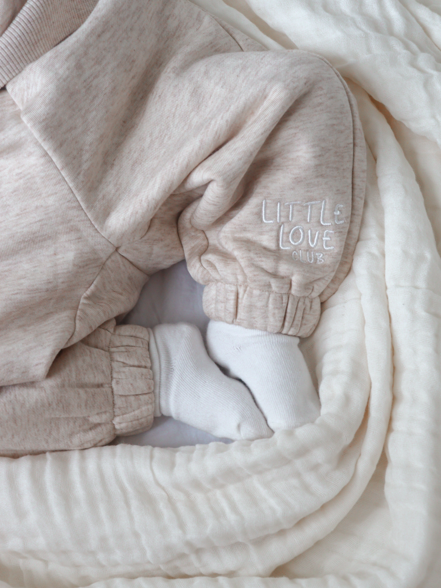 Comfort meets style with our embroidered 'Little Love Club' Tracksuit. Made from thick, luxuriously soft merino wool & cotton fabric with 'Little Love Club' embroidered on the chest and pant leg, it is the perfect gender neutral set for your little love. #tracksuit #merinowool #cottonblend #babytracksuit #winterwardrobe