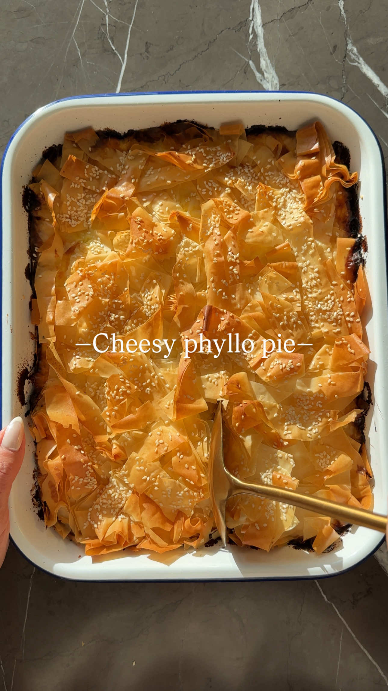 Cheesy Phyllo Ribbon Pie 🤌 This dish is put together in minutes, so delicious and perfect for hosting, or just a light dinner next to salad.  Ingredients: 🧀Leftover cheeses (any variety, shredded or crumbled) 1 cup sour cream/1 cup cottage cheese/1 cup crumbled feta/ 2 cups shredded cheese of your choice 🥚2 eggs 🌾1 package of phyllo dough Cooking spray  Sesame seeds (optional) Instructions: Prep the Phyllo: Unroll the phyllo dough and re-roll it into a log. Slice the log into ½-inch pieces. Assemble the Base: Spray a baking pan and layer half of the phyllo slices. Open up the ribbons and let them fall naturally into the pan. Prepare the Filling: Mix all the cheeses you have on hand in a bowl. Add 2 eggs and stir until combined. Add the Filling: Pour the cheese mixture over the phyllo ribbons in the pan. Top with the remaining phyllo ribbons, spreading them evenly. Finish & Bake: Spray the top with more cooking spray and sprinkle sesame seeds if desired. Bake at 375°F (190°C) until golden and crisp, about 40 minutes. Serve: Let it cool slightly before cutting into squares or wedges. Perfect for gatherings or as a quick, satisfying snack! #sivanskitchen #explorepage #easy #baking #EasyRecipes  #phyllo #cheese #fyp 