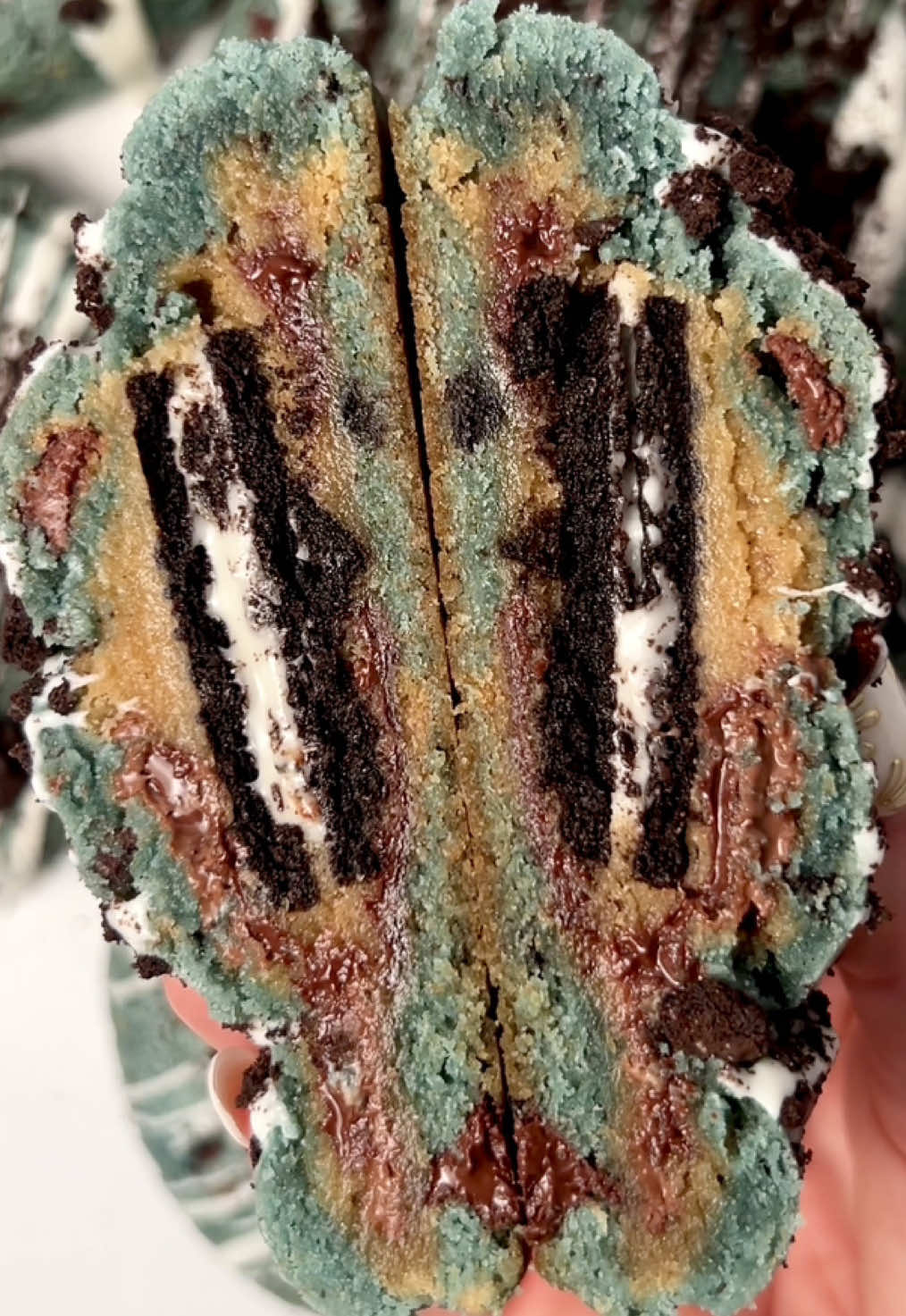 The best Cookie Monster cookie recipe you will ever try 🥰🍪 #cookiemonstercookies #oreocookies #cookiesandcream #cookiesncreamcookies #oreostuffedcookies  Recipe: For the chocolate chip dough: 2 1/4 cups APF 1 tsp cornstarch  1/2 tsp baking soda  1/2 tsp baking powder  1/2 tsp salt  1 cup unsalted butter, room temp  2/3 cup dark brown sugar  1/2 cup sugar  1 egg, room temp 1 yolk, room temp  1/2 tbsp vanilla or vanilla bean paste  1 1/2 cup semi sweet chocolate  For the Cookie Monster dough: 1 cup cold butter, unsalted  1 cup light brown sugar  1/2 cup granulated sugar  2 eggs, room temp 2 yolks, room temp  1 tbsp vanilla  Blue gel food coloring 4 cups APF 1 tbsp cornstarch  1 tsp baking soda  1 tsp baking powder  1 tsp salt  1 cup chocolate chips  1 cup Oreo pieces  1 cup chips ahoy pieces  *approximately 1/2-2/3 cup melted white chocolate and 1/2 cup crushed Oreo for topping 
