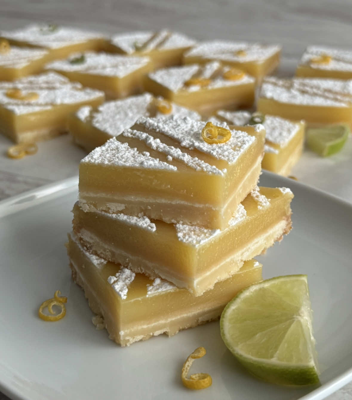 🍋وصفة مربعات الليمون الكلاسيكية المنعشة / Classic bright Lemon Bars recipe with  shortbread crust My Classic lemon bars recipe with shortbread crust is bright, tangy and buttery treats ready in under an hour. Try this easy homemade recipe today! وصفة مربعات الليمون الكلاسيكية هي حلوى منعشة، تمتع بهذه الوصفة المنزلية سهلة التحضير اليوم! ⬇️⬇️RECIPE BELLOW / الوصفة بالأسفل⬇️⬇️ Classic Lemon Bars  ▪️Ingredients: 1 & 1/2  cup caster sugar (300g) 1 Tbsp lemon zest  2 eggs + 2 egg yolks  1  tsp  vanilla 1/2 cup flour (62g) 2/3  cup  lemon juice (165ml) 1/3  cup  double cream (80ml) ▪️Shortbread crust: 2  cups  flour (250g) 1/2  cup  icing sugar (62g) 150 g  soft butter (1 & 1/2 sticks) ▪️pan size 23x30 cm (9x12 inch) 🔥bake at 150°c (300°f) ⏰ 15 min for the crust & 15 min. with the filling. ❄️In the fridge for at least 4 hr. مربعات الليمون الكلاسيكية ▪️ المكونات: ١ و ١/٢  كوب سكر (٣٠٠غ)  ١  م.ك  بشر قشر الليمون  ٢ بيض + ٢ صفار بيض ١/٢  م.ص  ڤانيللا ١/٢  كوب طحين (٦٢غ) ٢/٣  كوب عصير ليمون (١٦٥مل) ١/٣  كوب كريمة خفق سائلة (٨٠مل)  ▪️مكونات طبقة البسكوت: ٢  كوب طحين (٢٥٠غ) ١/٢  كوب سكر مطحون (٦٢غ) ١٥٠ غ زبدة طرية (٢/٣ كوب) ▪️قالب مقاس ٢٣x٣٠سم (٩x12 إنش) 🔥يُخبز في فرن ١٥٠°م (٣٠٠°ف) ⏰تخبز القاعدة ١٥ دقيقة ثم مع الحشوة ١٥ دقيقة ❄️يبرّد بالثلاجة ٤ ساعات عالأقل. *️⃣*️⃣ SUBSCRIBE  NOW  to stay updated on the latest recipes! ▶️Youtube/يوتيوب https://youtube.com/@bakewithlamees?si=BaOdSd-JR9q8MoKY *️⃣*️⃣ FOLLOW me  TODAY  to stay updated on the latest recipes! ▶️Facebook/فيسبوك https://www.facebook.com/share/16TcRoA51s/?mibextid=wwXIfr ▶️Instagram/انستاغرام https://www.instagram.com/bakewithlamees?igsh=MWx6djBrZnY5Nzk2bg== ▶️Threads/ثريدز https://www.threads.com/@bakewithlamees?igshid=NTc4MTIwNjQ2YQ== #Bakewithlamees #lemonbars #shortcrust #Foodie #baking #bakersofinstagram #yummy #SummerDesserts #easybaking #lemonsquares #Homebaking #مربعات_الليمون #حلويات_صيفية #حلويات 