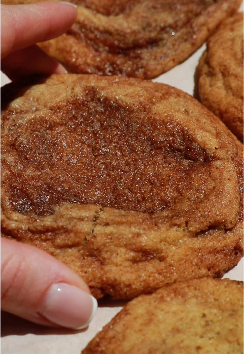 Cinnamon Roll Sugar Cookies - **More details are written on my blog linked in my bio if you want to print the recipe! I highly recommend reading it there to make following the recipe easier ☺️ Cookie Dough Ingredients - - 1 1/4 cup all-purpose flour (166g) - 1/2 tsp ground cinnamon - 1/4 tsp baking powder - 1/4 tsp fine salt - 1/2 tsp baking soda - 1/2 cup room temperature unsalted butter (NOT SOFTENED!!! If your butter is too soft/warm when making the dough, your cookies will spread too much) (113g) - 1/2 cup granulated sugar (105g) - 2 tbsp light or dark brown sugar (20g) - 1 tsp pure vanilla extract (add more or less to taste) - 1 large room temperature egg Cinnamon Filling Ingredients - - 2 tbsp unsalted softened butter (30g) - 2 1/2 tbsp packed light or dark brown sugar (42g) - 2 1/4 tsp all-purpose flour - 1 1/2 tsp ground cinnamon (add more or less to taste) Cookie Dough Instructions - - In a medium mixing bowl, cream together the room temperature butter (not softened or melted!!! Room temp!!!), granulated sugar, and brown sugar. I like to do this with a rubber spatula and mix well until it’s smooth. You can also use a stand mixer with a paddle attachment or an electric hand mixer.  - Add the egg and vanilla extract and mix until very well combined.  - In a separate bowl, whisk together the dry ingredients.  - Add the dry ingredients to the wet and begin mixing slowly with your rubber spatula. Mix until everything is just combined and remember to never over-mix! Cinnamon Filling Instructions - - In a small bowl, combine all of the cinnamon filling ingredients and mix well.  - Place this bowl in the freezer for ~5-8 minutes until it’s very firm to the touch. Assembly & Baking - - Preheat your oven to 350 degrees F and line a baking sheet with parchment paper (I use two baking sheets for this recipe as the cookies will spread out while baking). - Once your filling is firm, spread half of the cookie dough out onto the bottom of the mixing bowl (I like to push the remaining cookie dough to the side of the bowl as opposed to taking it out and dirtying up another bowl).  - Using a 1/2 or 1 tsp, scoop the firm cinnamon roll filling out and place it all around the top of the spread out cookie dough. Once you have half of the cinnamon filling spread over the first half of the dough in pieces, spread the remaining dough overtop and press it down gently to really set the filling into place.  - Lastly, scoop the remaining cinnamon filling on top of the dough. Make sure you spread out the cinnamon filling pieces to ensure that you have an even distribution of cinnamon throughout each cookie once they are baked.  - Using a cookie dough scoop, evenly scoop out 10-12 cookie dough balls. Roll them into neat circles, place them a few inches apart from one another on your baking sheet, and bake for 8-10 minutes or until they are just slightly golden on the edge. The baking time will vary depending on your oven so be sure to keep an eye on them! - Allow to cool before serving and enjoy! **OPTIONAL: If you would like slightly thicker cookies, you can cover the cookie dough balls  and refrigerate them overnight. This will ensure that they don’t spread out too much if you’re worried about that and if you want them to be slightly thicker than mine!  #cinnamonrolls #bakingvideos #foodtutorials #recipeideas #dessert #baking #cookiedough 
