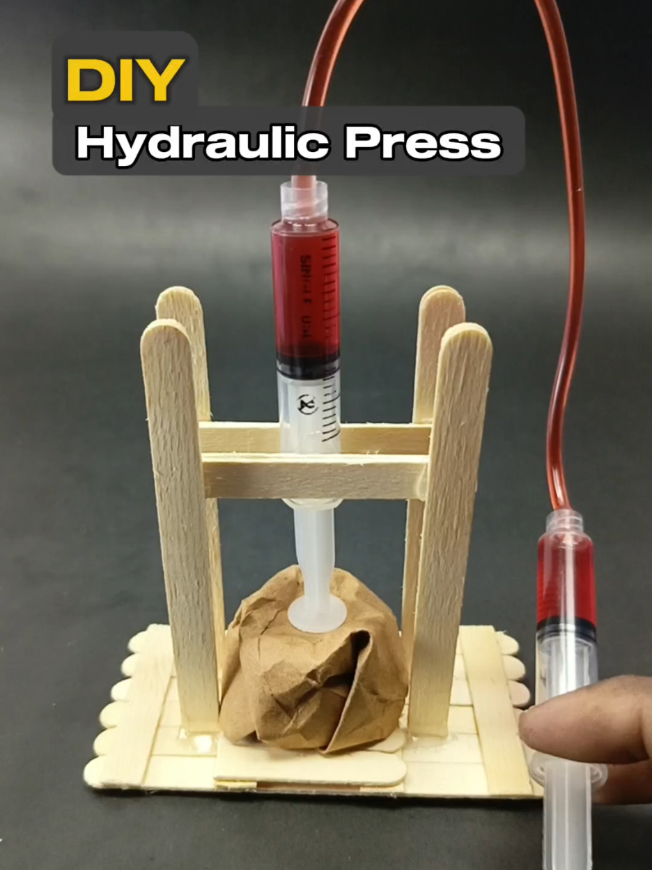 Mini Hydraulic Press Using Syringes! 😲💉 | DIY Science Project This mini press works with water pressure only! 💧💪 Made with syringes, sticks, and paper — simple but powerful!  #diyproject #hydraulicpress #scienceexperiment #minipress #stem #crafts #tiktokdiy #engineeringfun #lifehacks #creativebuilds #HANDMADE #geniusidea #syringehack #sciencetok #cardboardcraft #MA_DIY_TV_Shorts
