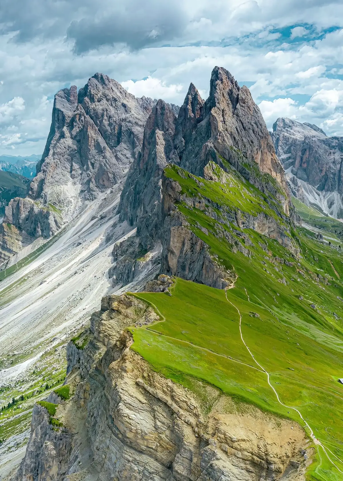 The Dolomites of northern Italy are nature’s boldest brushstrokes—vast, jagged towers of pale rock that rise suddenly from green valleys, slicing the sky with their sharp, dramatic beauty. Formed from ancient coral reefs and sculpted by wind, water, and time, these peaks are both wild and elegant, like frozen waves caught mid-crash. At sunrise and sunset, they ignite in soft pinks and burning golds—enrosadira, the mountain’s daily sigh of light. Beneath the cliffs, the land softens into rolling pastures and alpine meadows, where wildflowers bloom with cheerful abandon and wooden huts rest beneath weathered trees. The air is crisp, clean, touched with the scent of pine and stone. Here, everything feels heightened—colors, sounds, silence. Even a simple walk becomes a kind of journey inward, as if the mountains pull not just your body, but your spirit upward. The Dolomites are a meeting point of cultures—Italian charm, Austrian precision, and the mysterious rhythm of the ancient Ladin people. Tiny villages cling to hillsides, their church towers rising like smaller echoes of the mountains behind them. Rifugi (mountain lodges) dot the high trails, offering warm polenta, sharp cheese, and laughter passed around like bread. Stories linger in the stones, in the winding paths, in the flicker of campfire light. In winter, the peaks wear white like royalty, calling skiers and snow-lovers to dance down their flanks. In summer, the trails open like veins, drawing hikers and dreamers into the heart of the high world. But no matter the season, the Dolomites remain a place of wonder—a landscape that humbles, heals, and inspires. They are not just mountains. They are poetry held in rock and sky, a place where the Earth remembers how to astonish. #travel #explore #world #italy #europe #fyp #foryoupage 