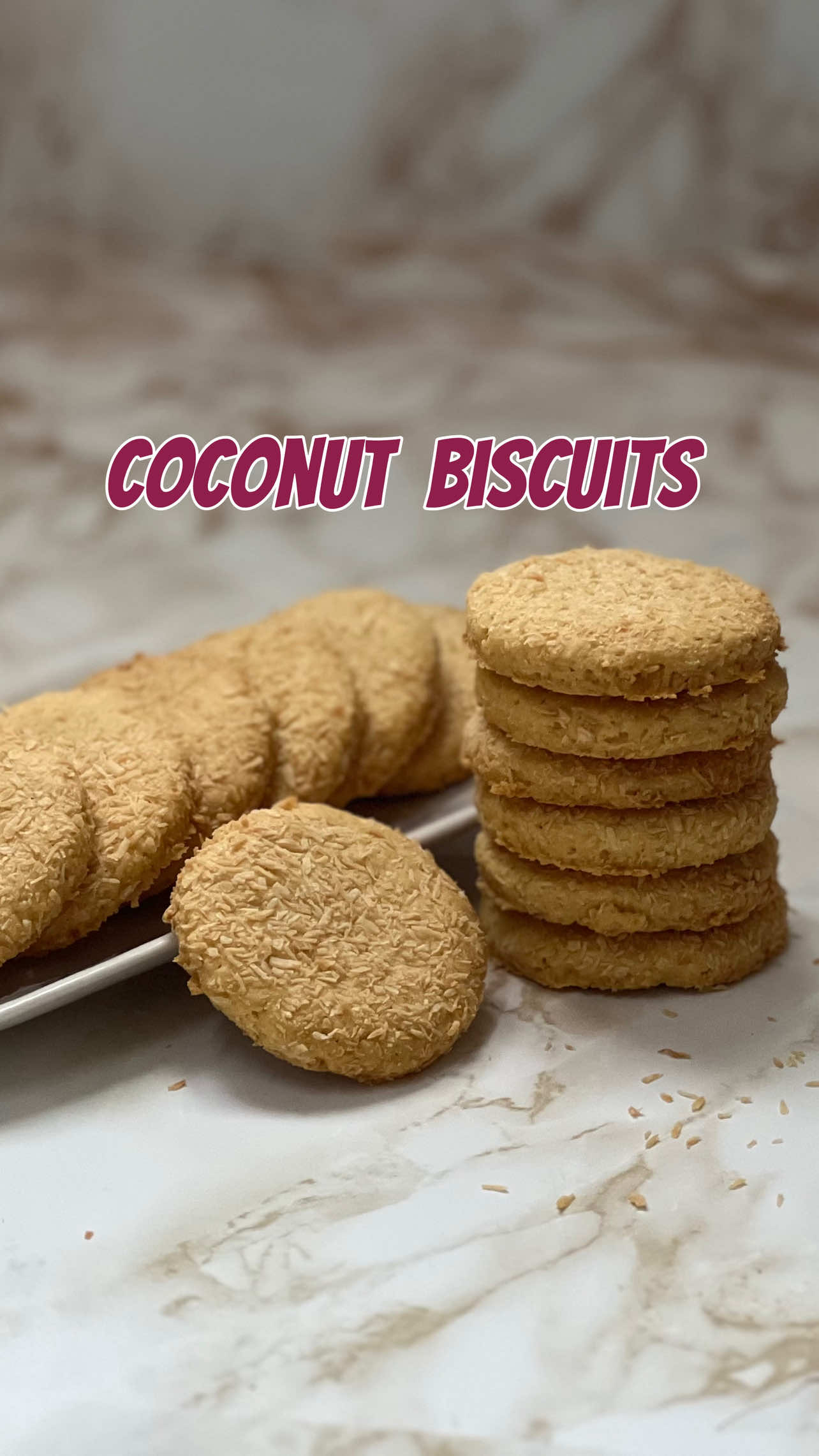 RECIPE OF COCONUT BISCUITS: Egg: 1 Sugar: 1/3 cup Oil: 1/4 cup Vanilla essence: 1 teaspoon  All purpose flour: 1 cup Cornflour: 1/3 cup Baking powder: 1 teaspoon  Salt: 1/4 teaspoon  Desiccated coconut: 3/4 cup INSTRUCTIONS: 1. Whisk the egg and sugar together until sugar is little dissolved. 2. Add oil and vanilla essence and mix well for another minute. 3. Sift the dry ingredients and add the desiccated coconut. 4. Mix well until a dough is formed. 5. Roll out the dough and sprinkle more desiccated coconut on the top. 6. Cut out round cookies and place them on a baking sheet. 7. Bake for 15-20 minutes at 160C or until the top becomes little golden. 8. Let them cool down for some time, serve and enjoy. #cookie #foryoupage❤️❤️ #EasyRecipe #trendin #baking #biscuits 