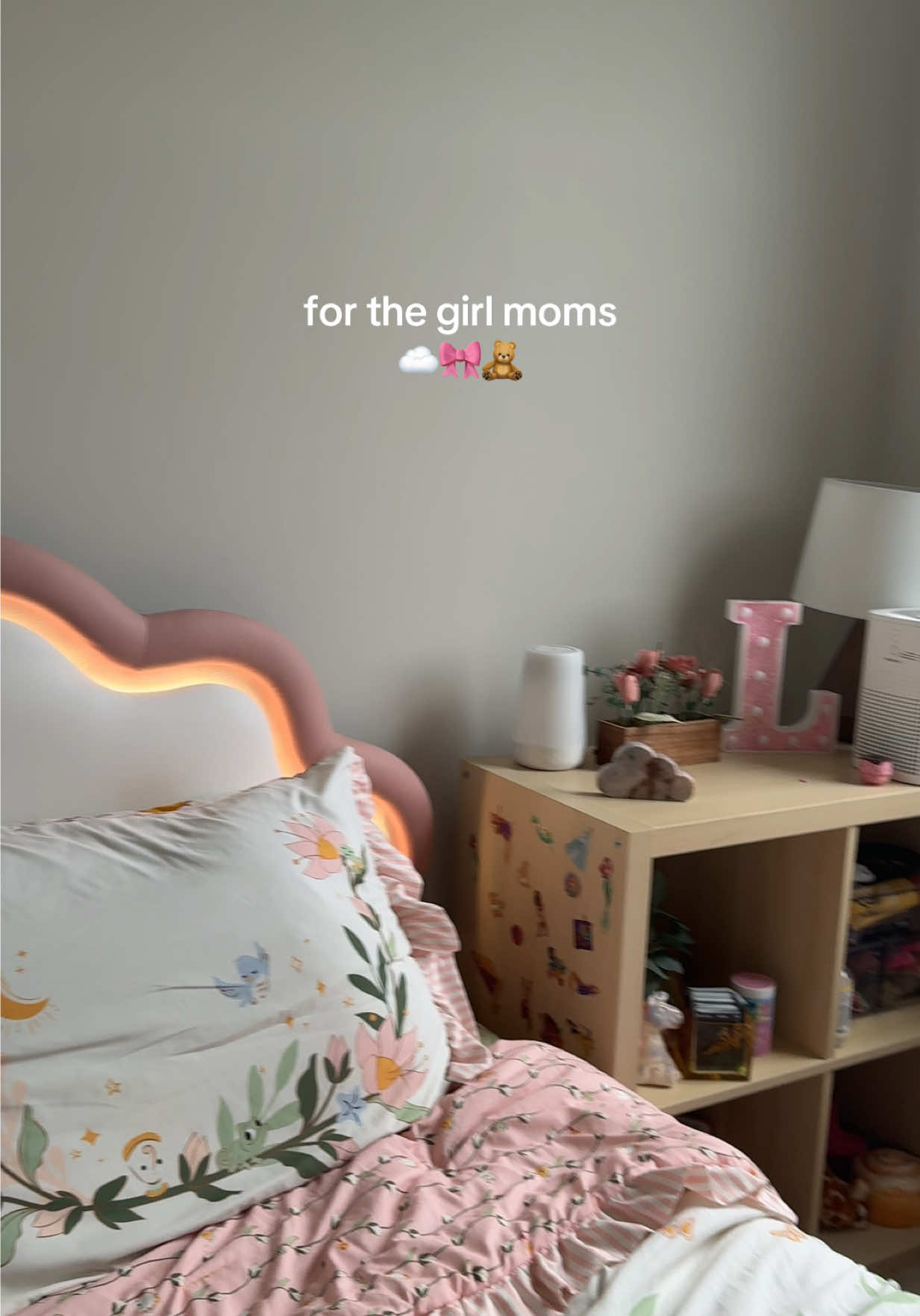 for the girl moms who want something cute but still functional!!! this is my favorite part of her room fr 🥲 this bed frame has a glowing cloud headboard, a remote with a bunchhh of settings, soft edges (no bruised shins here), and storage space underneath. i built it last summer while very pregnant in under an hour & it’s the main character of her whole room  #toddlerbed #girlbedroomdecor #pinkbed #cloudheadboard #ledbedframe #kidsbedframe #toddlerroomideas #kidsroominspo #girlbedframe #bedroomwithlights #ledheadboardbed #toddlerbedroomsetup #kidsroomglowup #cutekidsroom #pinktoddlerbed 