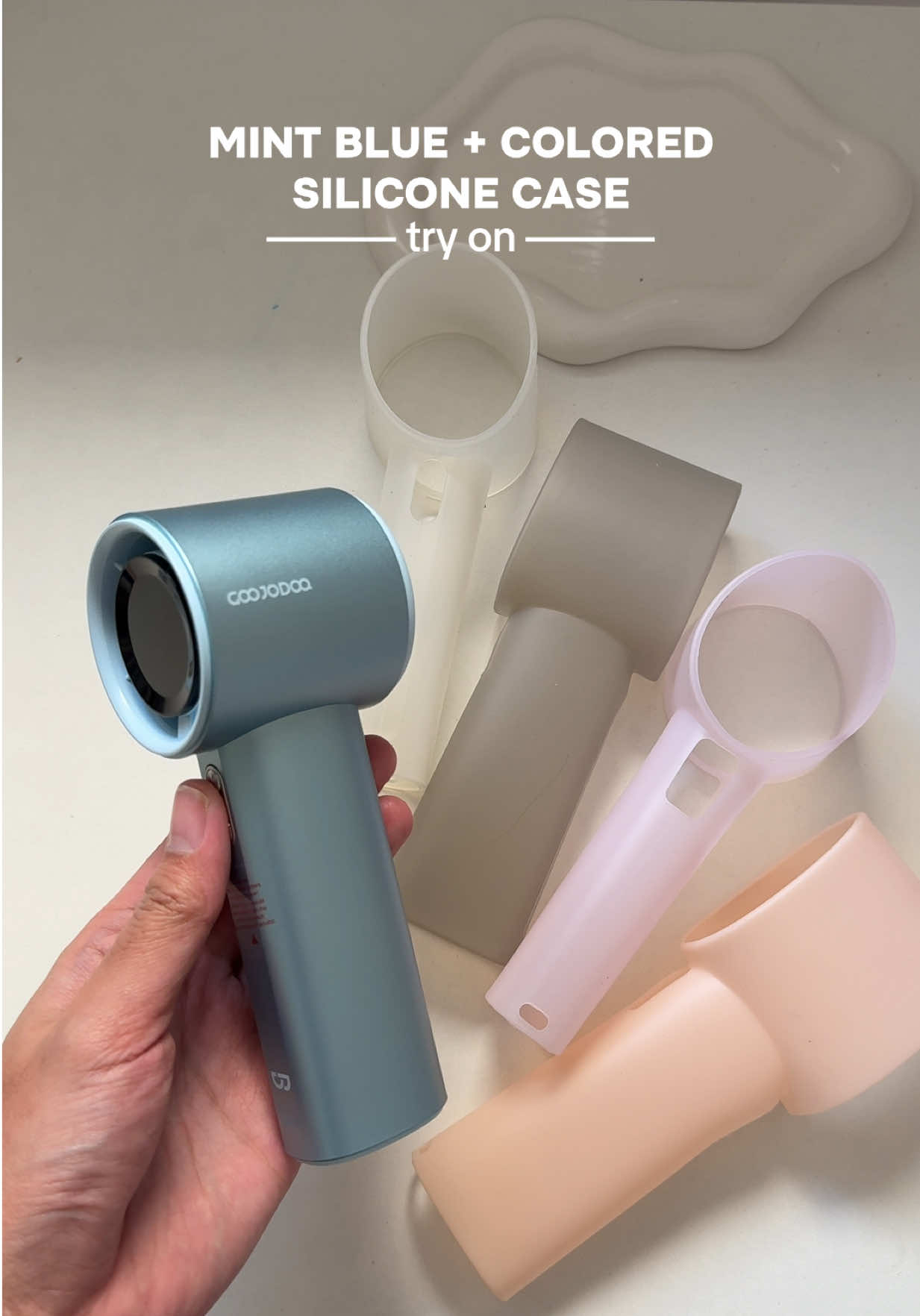 Replying to @reyes Colored silicone case TRY ON! 🩵💨 Which one do you like the most? #goojodoq #goojodoqfan #siliconecase #turbofan #protectivecase #minifan #mintblue 