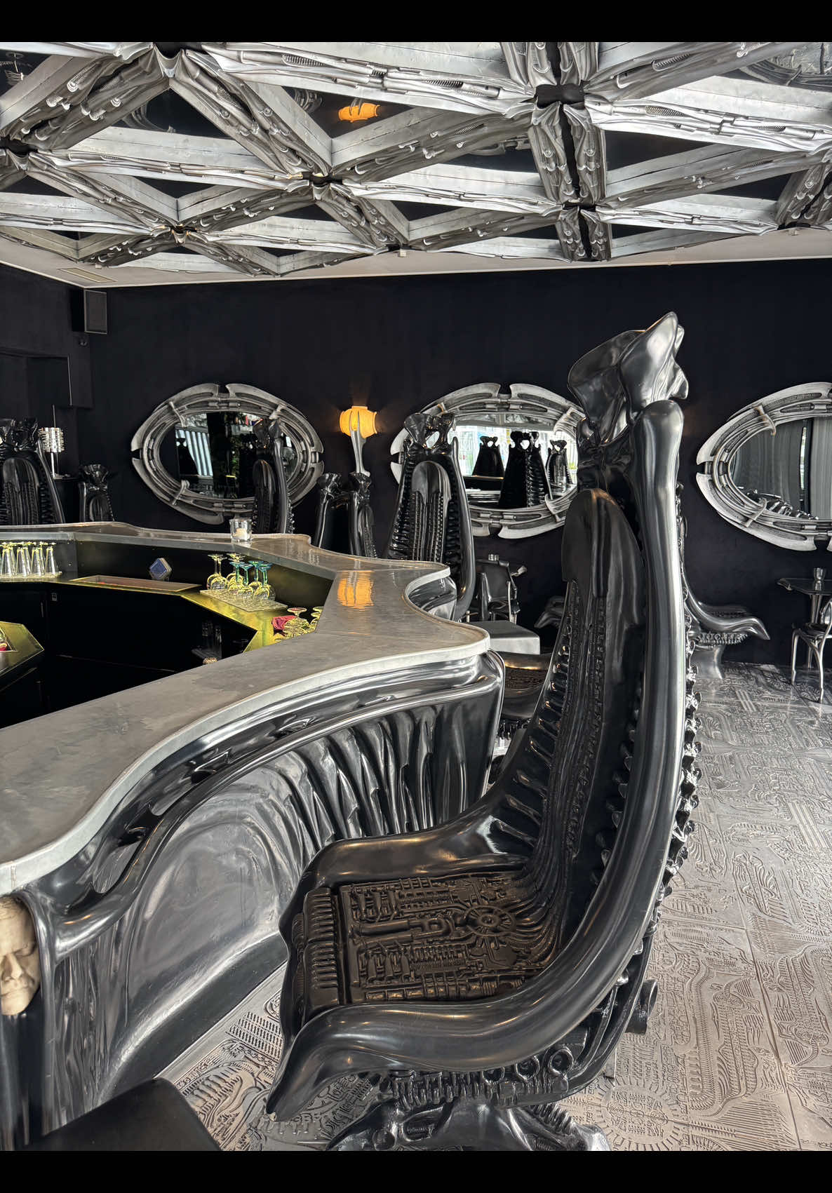 After winning an Oscar for visual effects in Alien, H.R. Giger returned to his hometown Chur, Switzerland to build something truly unique. A bar that looks and feels like stepping into one of his dark biomechanical nightmares. Opened in 1992, this was the first-ever Giger Bar. The design is raw and industrial, filled with sculptural elements, eerie textures, and the original Harkonnen Chairs, designed for a Dune movie that was never made. Btw, you can still order & buy original Harkonnen chairs that will be made for you.  Many fans know the Giger Bar in Gruyères, with its famous alien-ribcage ceilings, next to the HR Giger Museum. But this one in Chur, Switzerland’s oldest city, came first. It’s also one of the last. There was once a Giger-themed bar in Tokyo, and even a Giger-designed room at The Limelight nightclub in New York City. Both are now closed. Today, only two Giger Bars remain in the world, both in Switzerland. Chur and Gruyères are the only places, where you can walk right into it Giger’s universe. Would you visit a bar designed by one of the most influential sci-fi artists of all time? 👉 Follow @taniaparfe for surreal spots you can actually visit. #GigerBar #HRGiger #AlienDesign #DuneArt #HarkonnenChair   