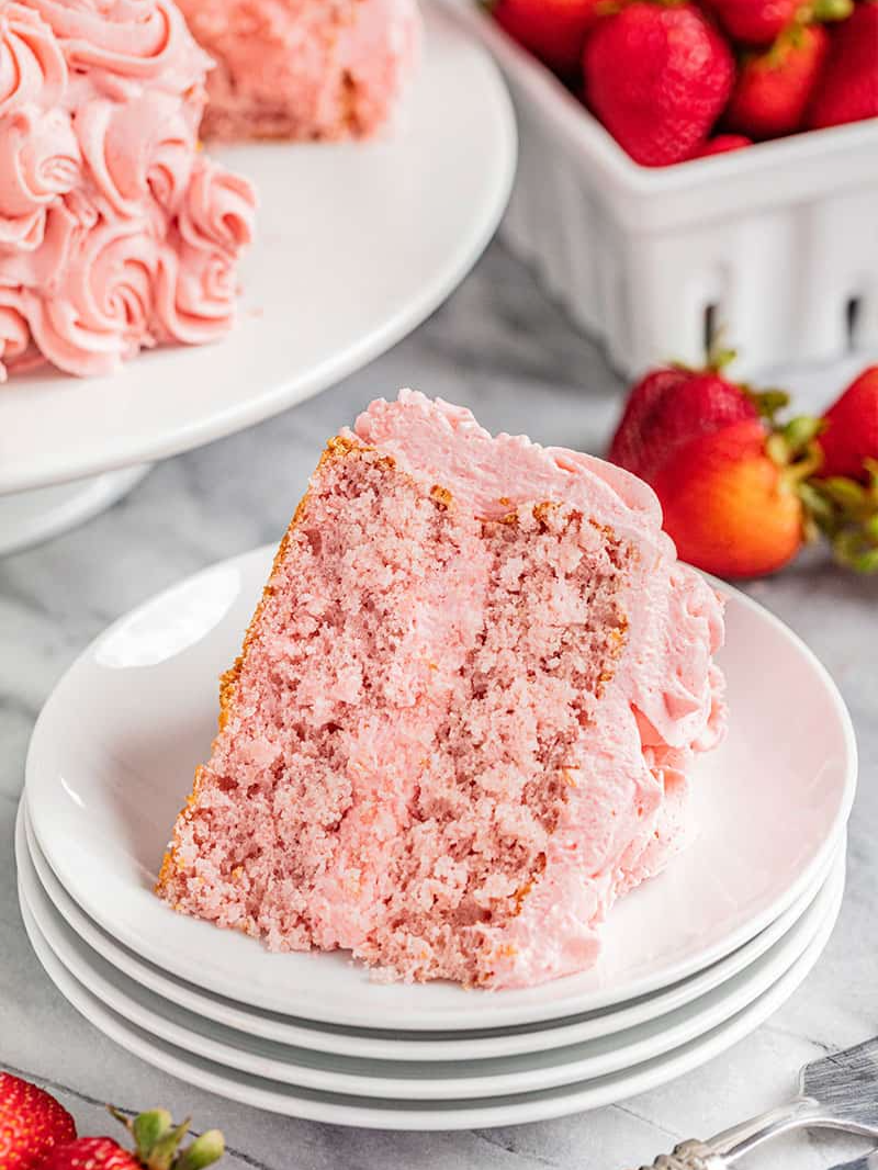 This Strawberry Cake is packed with real strawberries and topped with a light Chantilly cream frosting for a cake that is as beautiful as it is delicious. #strawberry #cake #dessert #strawberrycake