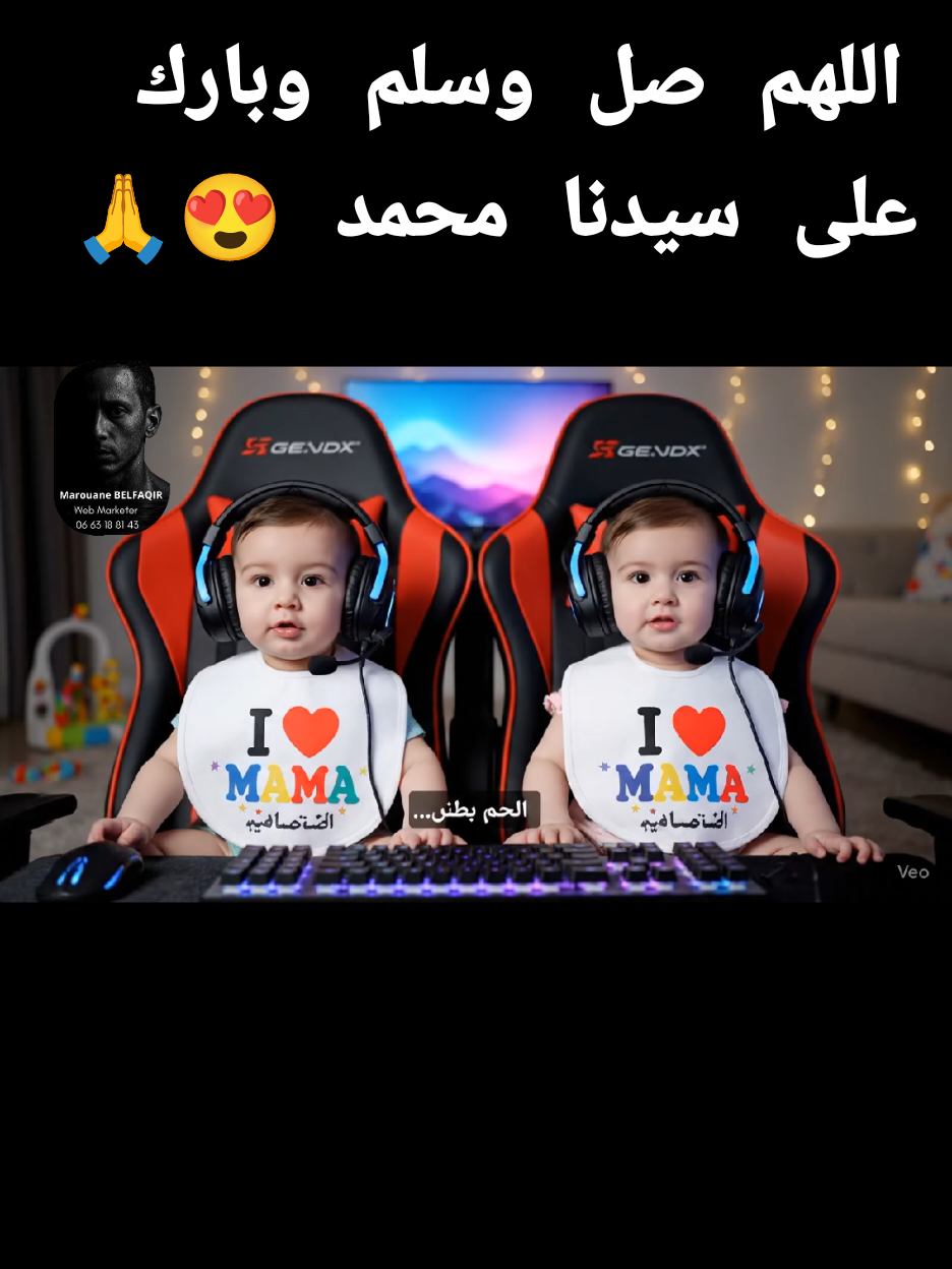 A cozy, softly lit living room with baby toys and a gaming setup. Two 8-month-old twin babies — one boy and one girl — sit side by side in an oversized gamer chair built for two, in front of a glowing keyboard and screen. Both wear large gaming headsets and matching bibs with cartoon controllers. The name 