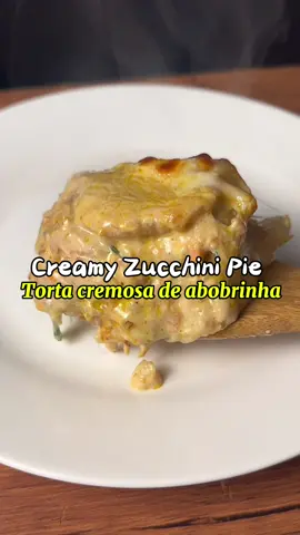 Creamy Zucchini Pie!  Ingredients: 3 potatoes, thinly sliced 🥔 (knife is fine) 1 carrot, grated 🥕 2 zucchini, thinly sliced with a mandoline Mozzarella cheese to taste 🧀 Salt and black pepper to taste Grated parmesan (optional) For the white cream 1 tbsp butter 1 small onion, finely chopped 1 tbsp cornstarch 200 ml milk 200 g milk cream (heavy cream) Salt and black pepper to taste How to make: Prepare the vegetables Slice the potatoes thinly (knife) and the zucchini thinly with a mandoline. Grate the carrot. Make the white cream In a saucepan, melt the butter and sauté the onion until soft and translucent. Add the grated carrot and cook for 1–2 minutes. Dissolve the cornstarch in the milk, then pour into the pan. Stir over medium heat until it starts to thicken. Add the milk cream, salt, and pepper, mix well, and turn off the heat. Assemble the pie: In a baking dish, make layers in this order: Zucchini Potato White cream Mozzarella Repeat until all ingredients are used, finishing with mozzarella on top. Bake: Bake in a preheated oven at 200 °C (390 °F) for about 35–45 minutes, until the vegetables are tender and the top is golden. #creamy #zucchini #pie 