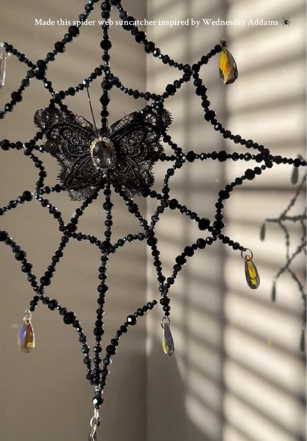 Crafted this one-of-a-kind spider web suncatcher with gothic elegance, black crystals, and moody detail — fully inspired by the iconic style of Wednesday Addams. ✝️✨ Whether you’re decorating your space in gothic glam, dark academia, or just embracing your inner villain era, this piece was made to catch the light and the drama. 🖤 Handmade with love, shadows, and sparkle 🕸️ Perfect for spooky decor lovers, goth girl rooms, and witchy vibes 🎓 Inspired by Nevermore Academy & timeless Addams Family energy  #spiderweb #suncatcher #wednesdaynetflix #wednesdayaddams #addamsfamily  #beadart 