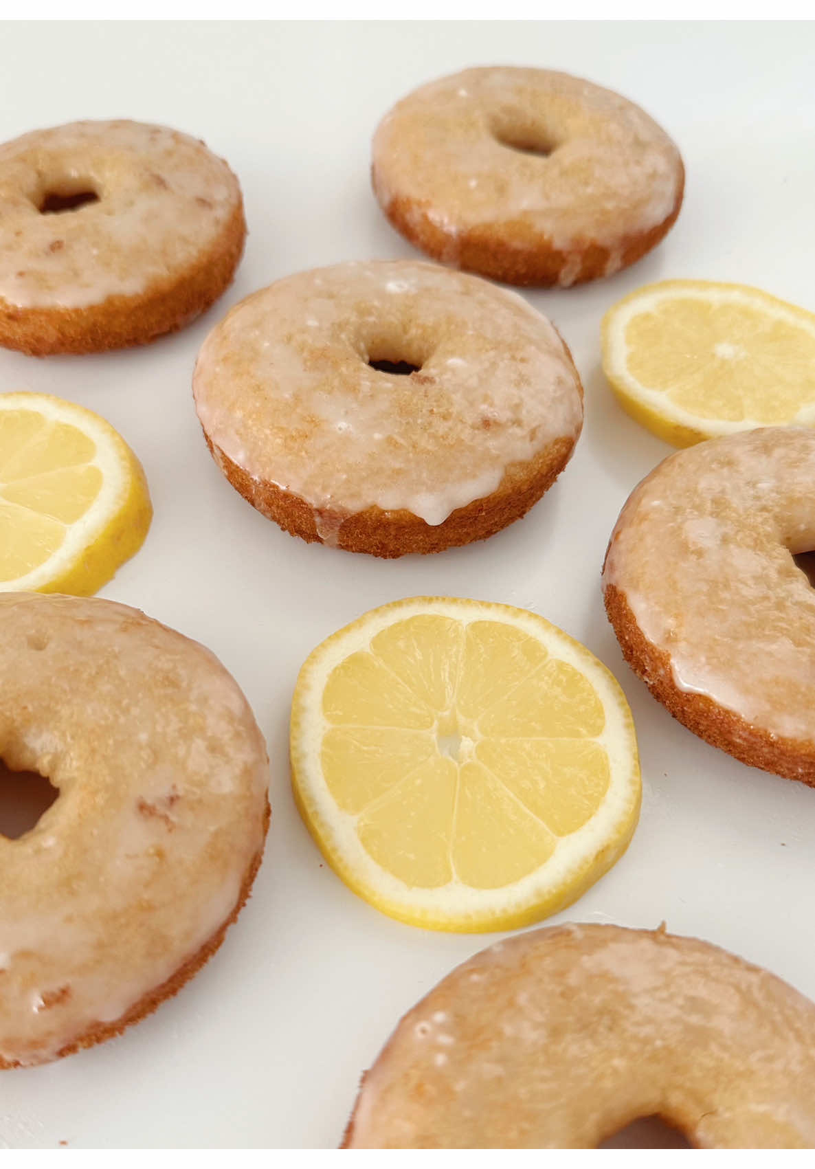 Glazed Lemon Donuts 🍋 Lemon Series Ep. 4 These cuties are light, airy and have a bright lemon flavor. This donut recipe comes together all in one bowl which makes for an easy weekend treat! Save this post or send it to a donut lover you know 💛  To make these Glazed Lemon Donuts start by preheating the oven to 350 degrees and butter a donut pan. In a large bowl massage the zest from one whole lemon with 3/4 cup of sugar. Next whisk in 1 egg until the two become pale yellow in color. Add in 1 cup Greek yogurt, 1/2 cup oil, 1/4 tsp lemon extract, 1 tsp vanilla extract and the juice of 1 lemon. Whisk until smooth. Fold in 1 1/4 cup flour, 1 tsp baking soda and 1/4 tsp salt. With a piping bag or small spoon add the donut batter to the pan leaving a bit of room at the top for the donuts to rise. Bake at 350 for 15 minutes or until a toothpick inserted inside comes out clean. Let the donuts fully cool before dunking them in a glaze made with 1 1/2 cups powdered sugar and the juice of 1 lemon. Enjoy the same day! 🍋💛 #lemon #donuts #EasyRecipe 