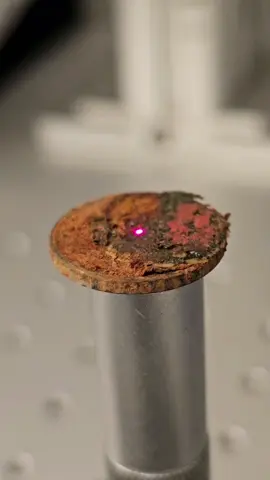 Laser cleaning a coin