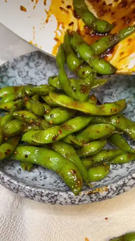 Edamame Recipe! Three minutes to the most addictive snack ever! These steamed edamame are coated in a bold, sweet, salty, and spicy glaze that makes them impossible to stop eating. Perfect as an appetizer, snack, or side! #edamame #snack #EasyRecipe #foodtiktok #costcofinds 