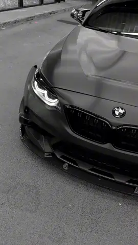The BMW M2 is compact, aggressive, and built for pure driving thrills. Under the hood, its 3.0-litre TwinPower Turbo inline-6 delivers 453hp, launching from 0–62mph in just 4.1 seconds. With rear-wheel drive, a perfectly balanced chassis, and precision steering, it’s a true driver’s car — equally at home on winding back roads or tearing up the track. Bold flared arches, quad exhausts, and a muscular stance give it presence, while the driver-focused interior features M sport seats, carbon fibre trim, and BMW’s latest iDrive tech. Small in size. Massive in attitude. The M2 is performance distilled to its purest form.#fyp #Cars #BMW 