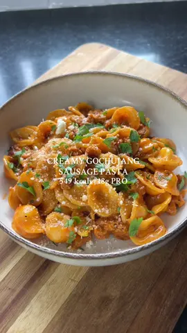 CREAMY GOCHUJANG SAUSAGE PASTA 🍝  This was so delicious and easy to put together 😍 Make sure to save for later and try for yourself☝🏼 •549 kcals per portion •18g PRO, 52g CHO, 30g FAT Serves 4: -240g of uncooked pasta of choice -1 tbsp of olive oil -2 cloves of garlic, minced -1 red onion, finely diced -4 large sausages, skins removed -1 tsp of paprika -Chilli flakes -20g of gochujang paste -100ml of light cream -100ml of pasta water -Salt/pepper -1 tbsp of Parmesan plus 4 tsp for garnish -Fresh parsley, chopped Method: 1. Add the pasta to a pot of boiling water. Cook for 8-10 minutes until al dente. Drain and keep pasta water. 2. Heat a pan on medium heat with oil. Add the garlic and onion and fry u til softened.  3. Remove the skin from the sausage and add to the pan. Break down and fry for 5-10 minutes. 4. Season with paprika and a sprinkle of chilli flakes. 5. Add the gochujang paste and cream. Mix well.  6. Add in the cooked pasta along with 100ml of pasta water. Mix together and simmer until the sauce reduces (add more water if needed). 7. Season with salt/pepper and mix in the parmesan. 8. Divide into 4 portions. Top each portion with 4 tsp of parmesan and parsley. Enjoy! #creamypasta #gochujang #sausagepasta #gochujangpasta #EasyRecipes  
