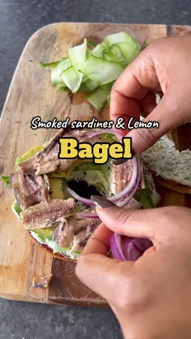 Smoked Sardine & Lemon Bagel 🥯🐟🍋 Smoky, zesty, creamy, fresh, this bagel is a flavour bomb. I swear sardines are one of the most underrated ingredients out there. They’re loaded with protein, omega-3s, and nutrients, and when paired with lemon cream cheese and buttery avocado? Next-level delicious. Perfect for a quick lunch, brunch, or even a fancy snack that feels restaurant-worthy but takes minutes to make. Ingredients (makes 1 bagel sandwich) ➡️1 fresh bagel (sesame, plain, or wholewheat) ➡️2-3 smoked sardines (drained if packed in oil, patted dry) ➡️2 Tbsp cream cheese (or vegan cream cheese) ➡️Zest of ½ lemon + 1 tsp lemon juice ➡️½ avocado, sliced ➡️4-5 cucumber ribbons or thin slices ➡️A few very thin slices of red onion ➡️Fresh dill or parsley, chopped ➡️Pinch of black pepper ➡️Optional: sprinkle of chilli flakes or smoked paprika Method 1️⃣ Toast the bagel until golden. 2️⃣ In a small bowl, mix cream cheese, lemon zest, and lemon juice. 3️⃣ Spread the lemon cream cheese generously on both halves. 4️⃣ Layer cucumber ribbons, avocado slices, and smoked sardines. 5️⃣ Add red onion slices and chopped dill/parsley. Season with black pepper (and optional chilli flakes or smoked paprika). 6️⃣ Serve immediately with an extra lemon wedge for squeezing. 💡 Extra flavour tip: Add capers or pickled jalapeños for a burst of tangy crunch that cuts through the richness beautifully. #SmokedSardineBagel #bagelrecipe #healthylunchideas #EasyLunchRecipes #bagel #qui#quickmealsrdines 
