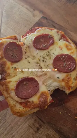 Recipe : Spread pizza sauce on 2 slices of white bread, add shredded mozzarella and pepperoni, close, and bake at 180 °C until golden and cheese melts. #gourmetfood #easyrecipeideas #sandwiches #quickrecipes #funrecipes 