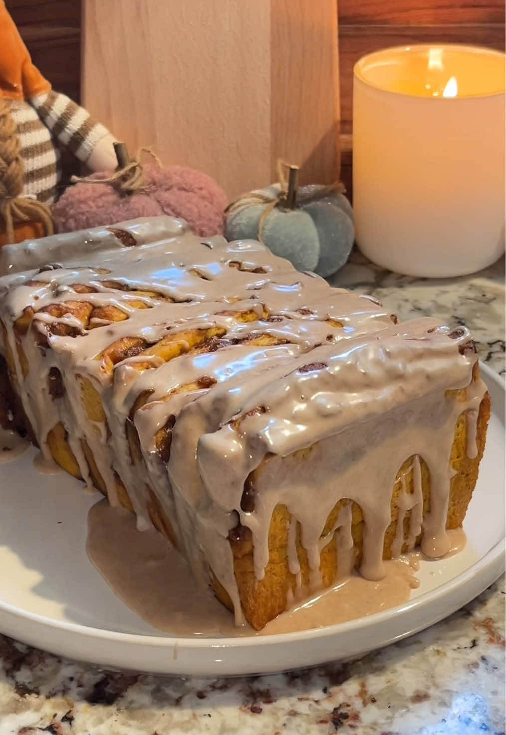 Pumpkil spice pull apart bread 🎃 its like a pumpkin cinnamon roll but in bread form! I came up with this recipe myself and i am so relieved it came out so soft and delicious! This was sooo good it was honestly so addicting. For the pumpkin dough: * 1 1/2 tsp active dry yeast * 85g whole milk, lukewarm * 30g brown sugar (half in the milk/yeast mixture and half in the rest of the recipe) * 350g all-purpose flour, plus 1-2 tbsp more if dough is still sticky * 1/2 tsp salt * 3/4 tsp pumpkin spice  * 108g pumpkin puree, weight after being patted dry (or use a cheesecloth) * 1 egg yolk * 1 tsp vanilla extract  * 70g unsalted butter, at room temperature Pumpkin Filling: * 1/3 cup pumpkin puree, patted dry * 3 tablespoon butter, melted * 1 teaspoon pumpkin spice  * 1/2 teaspoon kosher salt Cinnamon sugar filling: * 3/4 cup packed brown sugar * 1 tablespoon ground cinnamon FOR THE GLAZE: * ¾ cup powdered sugar * 2-3 teaspoons maple syrup * 2 teaspoons milk * 1 teaspoon vanilla extract * 1 teaspoon pumpkin pie spice *Mix all of your dough ingredients together (minus the butter) in a bowl or your mixer. Knead for a good 5-7 minutes until everything comes together.  *Add in your butter and knead again for a good 7-10 minutes until dough becomes elastic.  *If your dough is still sticky when mixing, add in 1-3 tbsp lore flour until it is nice and smooth. *cover and proof for 1 hour in a warm area. * Grease a 9x5 loaf pan and set aside. Turn your proofed dough out onto a lightly floured OR greased work surface.  * Roll dough into a 16x12 inch rectangle. *  Spread the pumpkin/melted butter mixture over the dough then sprinkle with the cinnamon sugar mixture on top. * Cut dough rectangle vertically into four 12x4 inch strips. Stack the strips then cut five 4x2 pieces. Place in prepared pan. Cover and let rise until almost double. (I let mine rise to the top of the pan then bake which took about 45 minutes for me)  * Bake at 350 degrees for 30 minutes or until golden. Cool loaf 10 minutes before removing from pan. Let cool completely before frosting. #pumpkinseason #cinnamonroll #pumpkinbread #falldesserts #fallbaking 