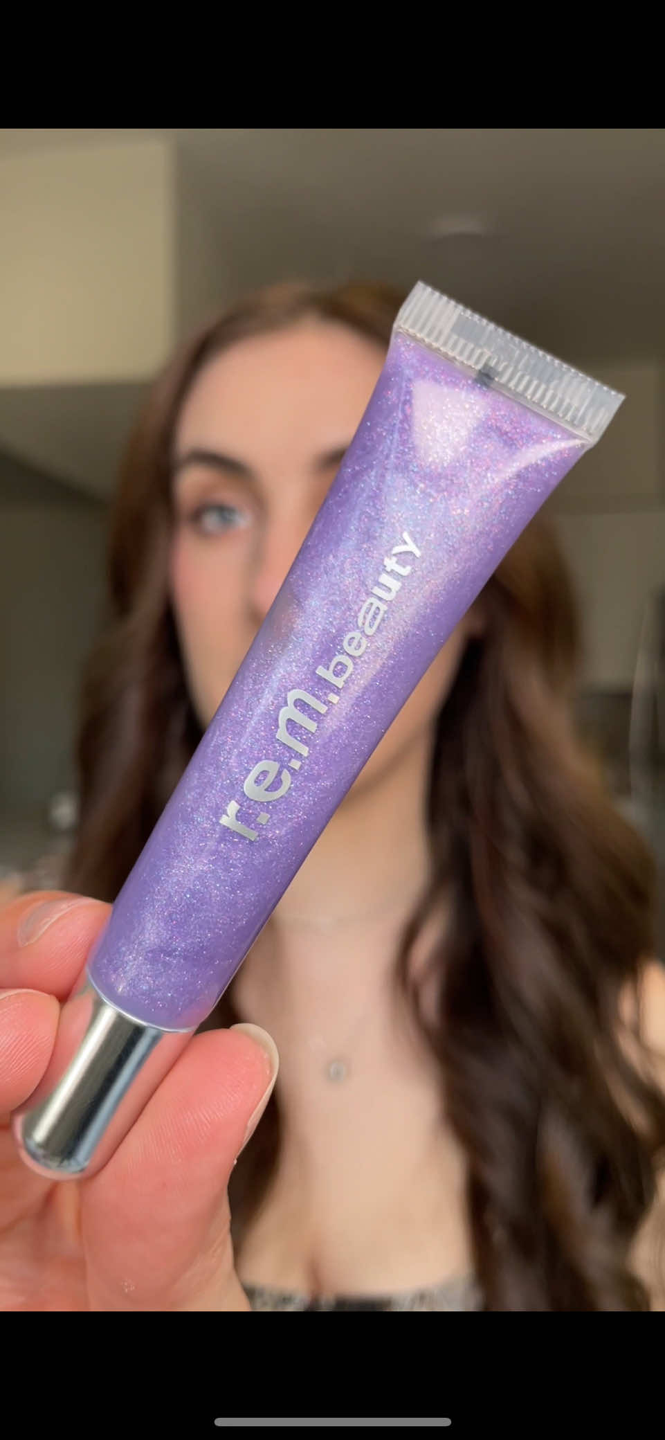 Replying to @Honest Phoebe THAT PLUMP!!?? New @r.e.m. beauty triple the plump on your collar plumping lip gloss in the shade Chuckie which is a gorgeous iridescent lavender @arianagrande #rembeauty #arianagrande #lipplumper #lipgloss #glitterlipgloss 