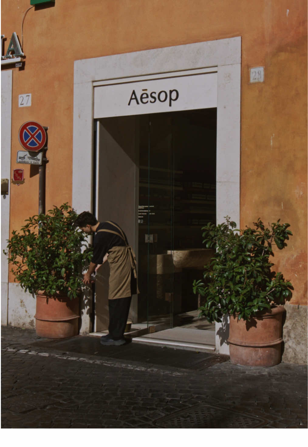 As the day whiles away and mopeds speed by, light moves around Aesop San Lorenzo in Lucina, in Rome.