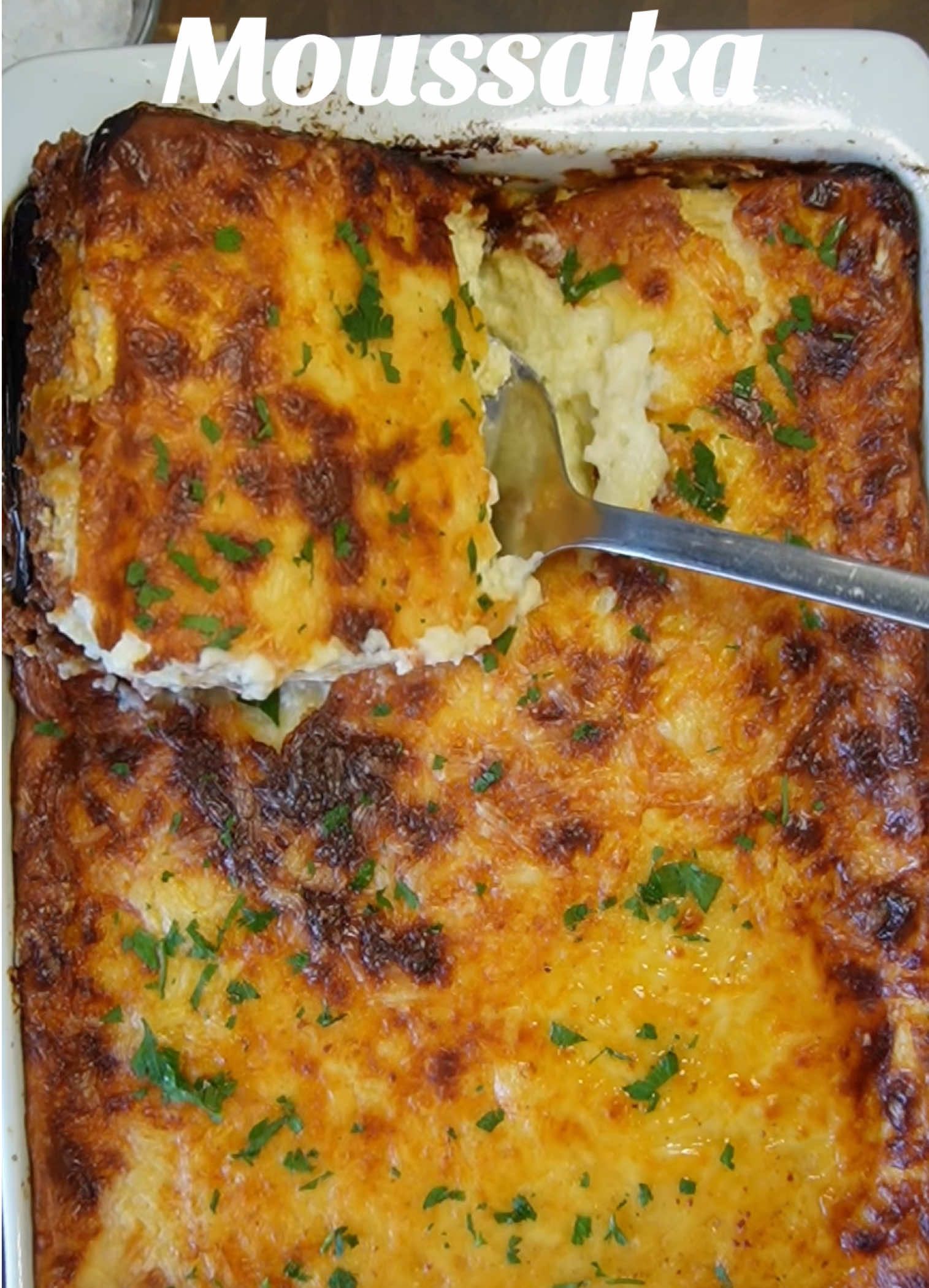 Moussaka 🔥🧡 Ingredients For the meat sauce 	•	800 g ground beef  	•	2 medium onions, finely chopped 	•	3 cloves garlic, minced 	•	3 tbsp olive oil 	•	400 g canned chopped tomatoes  	•	2 tbsp tomato paste 	•	1 tsp ground cinnamon 	•	1,3 tsp red chili powder  	•	2,5  tsp salt (adjust to taste) 	•	1 tsp black pepper  For the vegetables 	•	2 large eggplants  	•	2 large potatoes  peeled 	•	vegetable oil ( sunflower oil) for frying 	•	Salt For the béchamel sauce 	•	70 g butter 	•	70 g all-purpose flour 	•	750 ml whole milk  	•	A pinch of nutmeg 	•	2 eggs, beaten 	•	90 g Goada  Method 🍆🥔1. Prepare the vegetables 	1.	Slice eggplants lengthwise into ~1 cm thick slices. Sprinkle with salt and let sit 30 min to draw out bitterness. Pat dry. 	2.	Peel and slice potatoes into 5 mm–1 cm rounds. 	3.	fry the slices in oil until golden and Set aside. 🥩2. Make the meat sauce 	1.	Heat olive oil in a large skillet. Add onions and cook until soft. 	2.	Stir in garlic, cook briefly. 	3.	Add ground beef, cook until browned. Drain excess fat if needed. 	4.	Add tomato paste chopped tomatoes, cinnamon,salt, and pepper. 	5.  In low heat  20-25min until thickened. 🥛 3. Make the béchamel sauce 	1.	In a saucepan, melt butter over medium heat. 	2.	Stir in flour, cook 1 min to form a roux. 	3.	Gradually whisk milk and Seasoning  until smooth and thickened. 	4.	Let cool slightly, then whisk in beaten eggs and half the cheese. 4. Assemble 	1.	Preheat oven to 180 °C (355 °F). 	2.	Grease a large baking dish. 	3.	Layer potatoes on the bottom. 	4.	Add eggplant. 	5.	Spread all the meat sauce evenly. 	6.	Pour béchamel over the top and spread evenly. 	7.	Sprinkle with remaining cheese. 5. Bake 	•	Bake 45–50 min until golden and bubbling. 	•	Let rest 30 min before slicing (so it holds together). Καλή όρεξη! (Bon Appétit) Tag your friend who makes delicious recipes for you.❤️ #fyp #moussaka #greece #asmr #Recipe  		 	