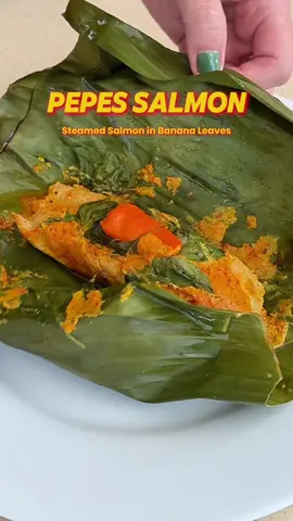 BTW this recipe is OIL FREE! Extra healthy 😋 AND I used Wild Caught Organic Alaskan Salmon from @hitokuchishoppu Their Organic Salmon contains NO antibiotics, NO artificial coloring and NO preservatives - unlike most salmon sold in grocery stores nowadays.  I personally only want the best for my family, so Organic Salmon is the way to go! Here’s the full PEPES SALMON Recipe ⬇️✨ STEP 1: CHAR SPICES 2 Big Red Chili 2 Birds Eye Chili 4 Garlic (15g) 6 Shallots (25g) 1 Candlenut 1.5cm Turmeric (5g) Roast spices on a dry pan til it gains a nice char.  STEP 2: BLEND SPICE PASTE Charred Spices A bit of water (about 30-50ml, just so spices blend smoothly) Blend the charred spices with a bit of water til it turns into a smooth paste.  STEP 3: SAUTÉ SPICE PASTE Spice Paste 1 Kaffir Lime Leaf 1 Indonesian Bay Leaf 1 Lemongrass Stalk (smashed) Salt & Mushroom Stock Powder (according to taste) about 0.5tsp each Sauté the spice paste in a pan, then add the leaves, lemongrass & seasonings. Keep sautéing til the spice paste becomes fragrant, thickens & deepens in color. STEP 4: STEAM SALMON Spice Paste Banana leaves 200g Salmon Fillet (cut to 2pcs) Lemon Basil Leaves Extra bird eye chili Rub the spice paste all over the salmon, then wrap the salmon in banana leaves with more spice paste, a handful of lemon basil leaves and 1 whole chili. Steam for anywhere between 8-15min (depending on thickness of Salmon Fillet). Enjoy! #salmon #pepes #indonesianfood #salmonrecipe #healthyrecipe 