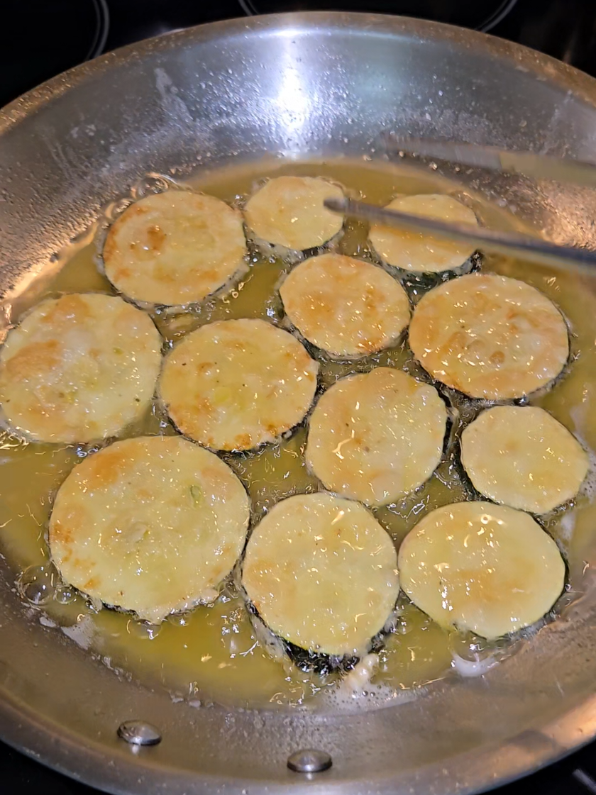 Nonna's fried zucchini on a stainless steel pan