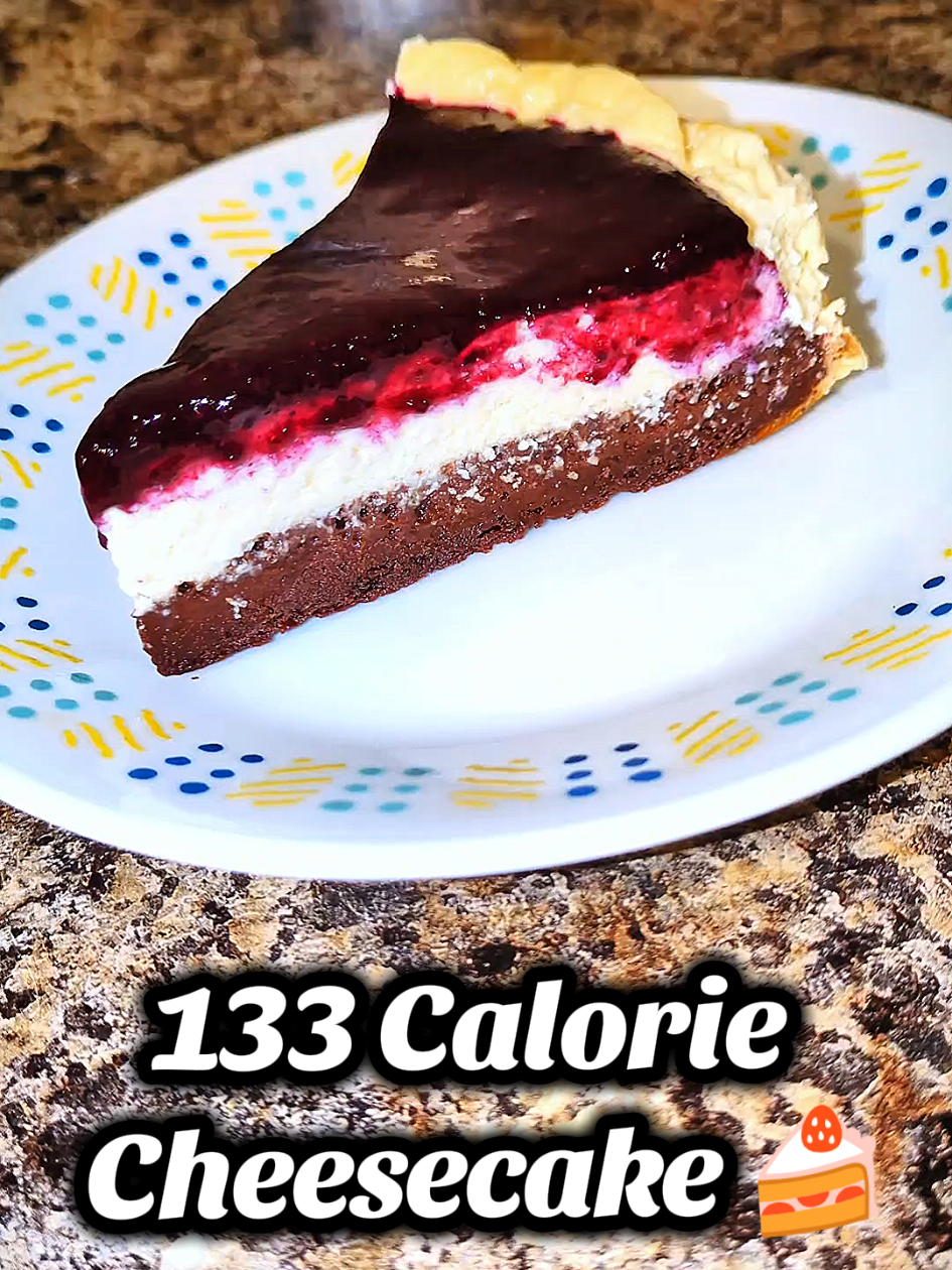 Low Cal, High Protein, Blueberry Cheesecake 🫐🍰 This Healthy but Tasty Cheesecake is a Fraction of the Calories of a Normal Cheesecake, has 0 Added Sugar, is High in Protein, Low in Fat, and You Can Eat the Entire Thing For Less Calories Slice From the Cheesecake Factory. 🍰Macros for 1 Slice (1/8 Cheesecake) - 133 Calories  15g Protein  12.8g Carbs  2.6g Fat 🎂Macros for Entire Cheesecake -  1,066 Calories   120.3g Protein 102.3g Carbs 20.6g Fat 🗒️Ingredients -  🍫Brownie Crust: - 42g Cocoa Powder  -  24g Chocolate Protein Powder  -  35g All Purpose/Oat Flour  -  50g Zero Calorie Sweetener  -  2g Baking Powder  -  Dash of Salt  -  4g Vanilla Extract  -  200g Diet Soda  🍰Cheesecake: - 500g Fat Free Cottage Cheese - 200g 0% Plain Greek Yogurt  - 2 Large Eggs - 75g Sugar Free Maple Syrup  - 6g All Purpose Flour  - 7g Zero Sugar Cheesecake Pudding Mix - 4g Vanilla Extract  🫐Blueberry Topping: -150g Berries of Choice  - Juice From Half a Lemon  - 20g Zero Calorie Sweetener  - 5g Cornstarch  📝Directions -  Brownie Crust Layer: 1️⃣ Combine Dry Ingredients for Brownie Crust Layer. Add Wet Ingredients and Slowly Stir Until Just Combined. 2️⃣ Pour into 8x8 or 9x9 Lightly Greased Spring Form Pan or Regular Pan Lined With Parchment Paper. 3️⃣ Bake in an Oven That's Preheated to 375⁰ For 15 Minutes Until Brownie is 60-75% Cooked or Until The Top of the Brownie is Solid Enough to Touch With Your Finger (Don't Want to Fully Cook). 4️⃣ Once Brownie is Out of Oven, Let Cool Completely. Cheesecake Filling Layer: 1️⃣Prepare Cheesecake Layer. Blend Cheesecake Filling Ingredients in Blender Until Combined 2️⃣ Pour Cheesecake Filling Over Cooked Brownie Layer  3️⃣ Bake in Oven Preheated to 350⁰ for 45 Minutes to 1 Hour Until Cheesecake is Firm to Touch But has Slight Jiggle When Shaken. Cheesecake Will Continue to Cook after Oven is Off. 5️⃣ Turn Oven Off and Open Oven Door Slightly and Leave Cheesecake in For 1 Hour. Then, Open Door Completely and Leave Cheesecake for Another 30 Minutes. This will Prevent Cracking. 5️⃣ Let Cheesecake Rest on Counter for 1-2 Hours until Completely Cooled Then Refrigerate For 2-3 Hours or Overnight. Berry Topping: 1️⃣Prepare Fruit Topping. In a Medium Saucepan, Mix everything Except Cornstarch Together. Bring to a Boil, then Reduce the Heat to Medium-low. Cook for 10 minutes, stirring frequently. Add Cornstarch Mixed with Water to Thicken Fruit Topping. Once Thickened, Remove From Heat and Let Cool. Assemble: 1️⃣Top Cheesecake With Berry Topping. Garnish With More Berries. Enjoy! Let Me Know in the Commenta if you Made this Recipe. Share With a Friend. #cheesecake #Highprotein #lowcal #healthyrecipes #proteinsnack 