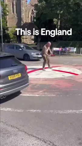 man painting roundabouts to England flags 