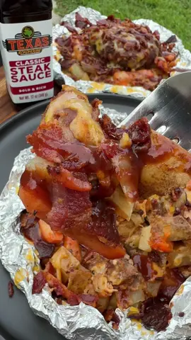 #sponsored Grilled Cheeseburger Foil Packets with @Texas Roadhouse Classic Steak Sauce are always a hit with the family for dinner! INGREDIENTS 4 potatoes, cut into cubes  1 onion, chopped  1/2 bag baby carrots, sliced  Olive oil  Steak seasoning  1 lb ground beef Texas Roadhouse Classic Steak Sauce  Shredded Colby Jack cheese  Bacon, cooked and crumbled  INSTRUCTIONS  Form the ground beef into 4 equal size patties. Wash and chop potatoes into cubes. Chop an onion. Slice baby carrots in half.  Lay out a couple of pieces of aluminum foil. Spray the foil with cooking spray. Add one chopped potato, a handful of onion and some baby carrots. Drizzle a little bit of olive oil over the veggies. Season with a little bit of steak seasoning. Top with a burger patty and season with a little bit more steak seasoning. Top the burger with a drizzle of Texas Roadhouse Classic Steak Sauce.  Wrap aluminum foil up tightly. Repeat until all 4 foil packets are assembled.  Heat a grill over medium heat. Place foil packets on the grill and cook for about 20-25 minutes or until the ground beef is fully cooked and the veggies are tender.  Carefully open the foil packet and add some shredded Colby Jack cheese. Place back on the grill to melt the cheese if needed. Top with crumbled bacon and a little bit more Texas Roadhouse Classic Steak Sauce. Enjoy!  #texasroadhouse #easydinner #EasyRecipes #foilpackets  