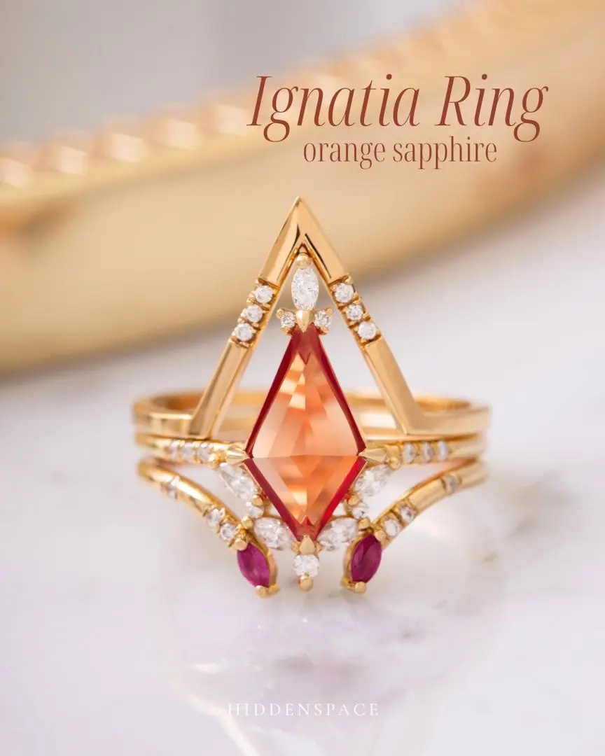 Ignatia Ring in glowing orange sapphire 🍊 ✨ Stacked with the Kite Halo Band and Marquise Open Band with rich ruby accents ❤️—a bold mix of color, shape, and drama. 💍 #IgnatiaRing #OrangeSapphire #RubyAccents # EngagementRingStack #RingStackGoals #ColorfulengagementRing #ArtDecoJeweley #FineJewelry #HiddenspaceJewelry #SapphireEngagementRing