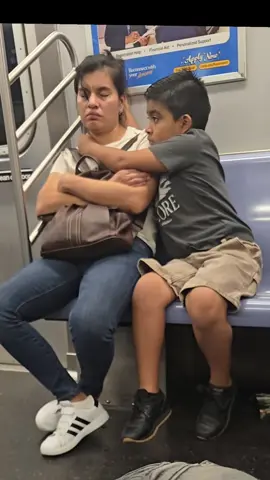A heart-warming moment captured camera shows a child protecting his mother by wrapping his arms around her while she sleeps on the train. #fyp #foryou #mother #mom #cutemoment 
