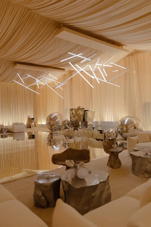 We turned a very traditional ballroom into a desert-at-night dreamscape. Inspired by Black Rock City, we draped every wall, washed the space in warm light, and layered in sculptural fixtures that felt like glowing constellations overhead. The mirrored stage and dance floor caught every reflection, making the room feel twice as big and twice as alive. We designed and built custom sand pit sculptures to anchor the space, pairing them with organic furnishings for a look that was modern, moody, and just a little surreal. Planning/Design/Floral: @shannonleahyevents  Photo: @vinuthnagaridipuri  Venue: @fsscottsdale  SLE Team: @camden_sle @jamie_sle @daylen_sle @tarakramer_sle @victoria__sle  #FourSeasonsScottsdaleWedding #ScottsdaleWedding #LuxuryWedding #DesertWedding #ArizonaWeddings #LuxuryWeddingPlanner #ScottsdaleBride #ModernWeddingDesign #WeddingInspo #WeddingGoals #ChicWedding #EditorialWedding #LuxuryEventPlanner #WeddingWeekend #TimelessWedding #WeddingDetailsMatter #DreamWeddingVenue #SouthwestWedding #MountainViewWedding #destinationwedding #BauduccoLover 