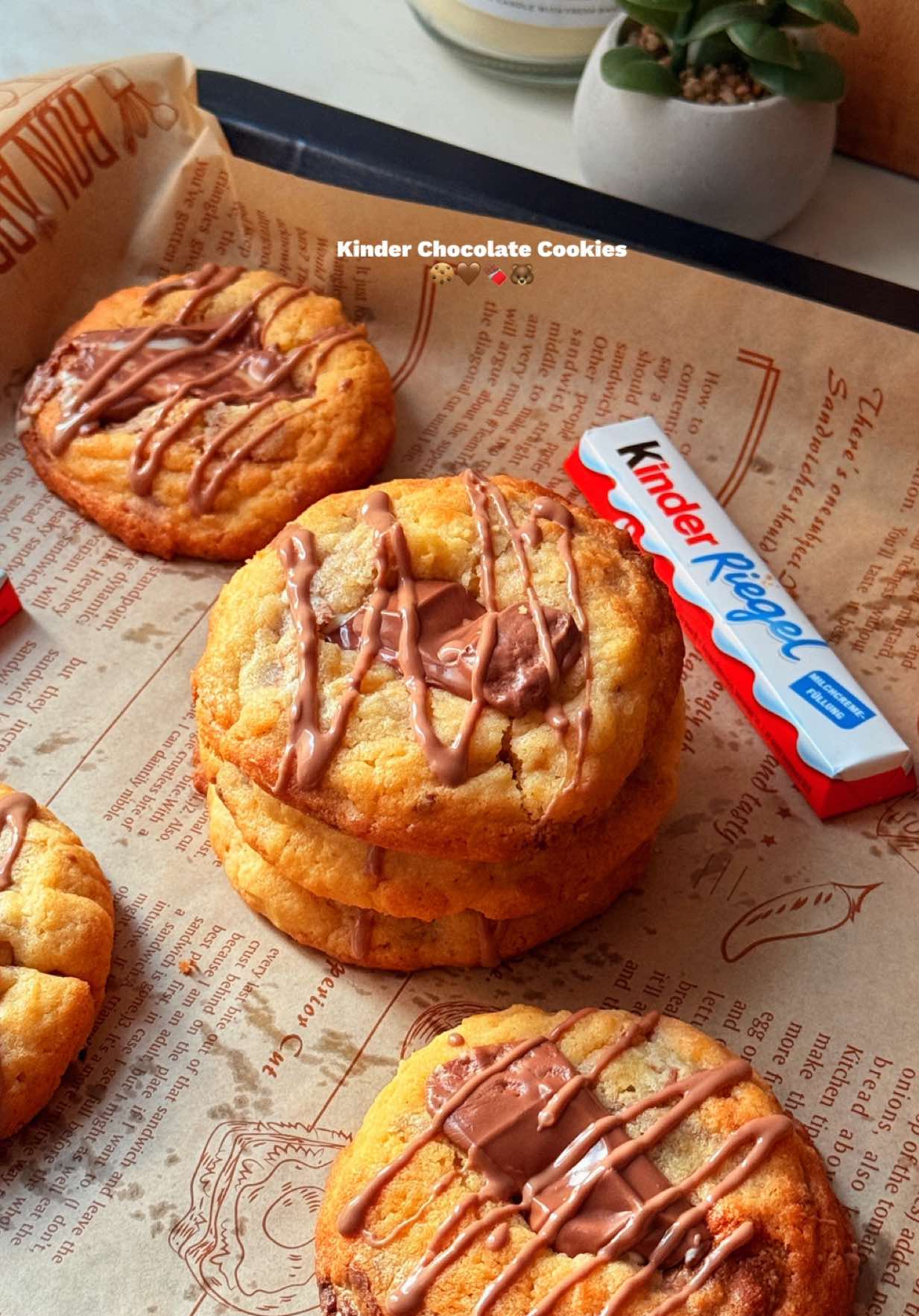 Kinder Chocolate Cookies - - 150g unsalted butter, softened - 2/3 cup - 100g granulated sugar - 1/2 cup - 80g light brown sugar - 1/3 cup + 1 tablespoon  - 1 teaspoon vanilla extract OR 1 teaspoon vanilla bean paste - 1 large egg + 1 large egg yolk - 220g all purpose flour - 1 3/4 cup - 4g baking powder - 1 teaspoon  - 150g Kinder Chocolate, chopped up into bigger chunks - 7-8 German Kinder Riegel bars or about 12 US Kinder Chocolate bars Instructions step by step: 1. Chop up the Kinder Chocolate into bigger chunks and set aside. 2. In a large bowl, mix together the butter, granulated sugar and brown sugar. 3. Next, mix in the egg, egg yolk and vanilla. 4. Add the flour along with the baking powder and mix until JUST COMBINED! 5. Lastly, fold in the Kinder Chocolate chunks. 6. Scoop out 10 equal cookies (70g each) onto a tray. 7. Cover with plastic wrap and refrigerate for a MINIMUM OF 1 HOUR (this is a must!) and up to 48 hours! 8. 10 minutes before you are ready to bake them, preheat your oven to 170•C (fan setting) 9. Place the cookies onto a baking tray lined with baking paper (make sure to leave some space between them) 10. Bake in the preheated oven for 10 to 12 minutes. 11. Once ready, top them with more chocolate and let them firm up a bit before serving. Enjoy :) 12. For more recipes, feel free to visit my blog - www.welcometoangieskitchen.com #cookie #cookiesoftiktok #asmrfood #kinderchocolate #EasyRecipe 