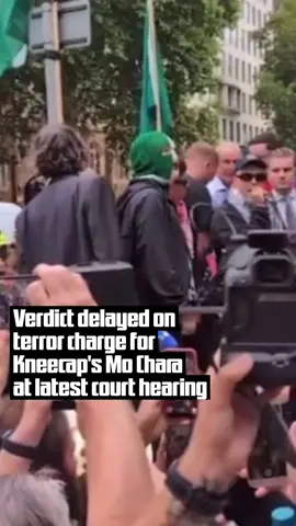 A judge has postponed today's hearing of a charge brought against Kneecap member Mo Chara after his defence argued that the case should be thrown out on a 