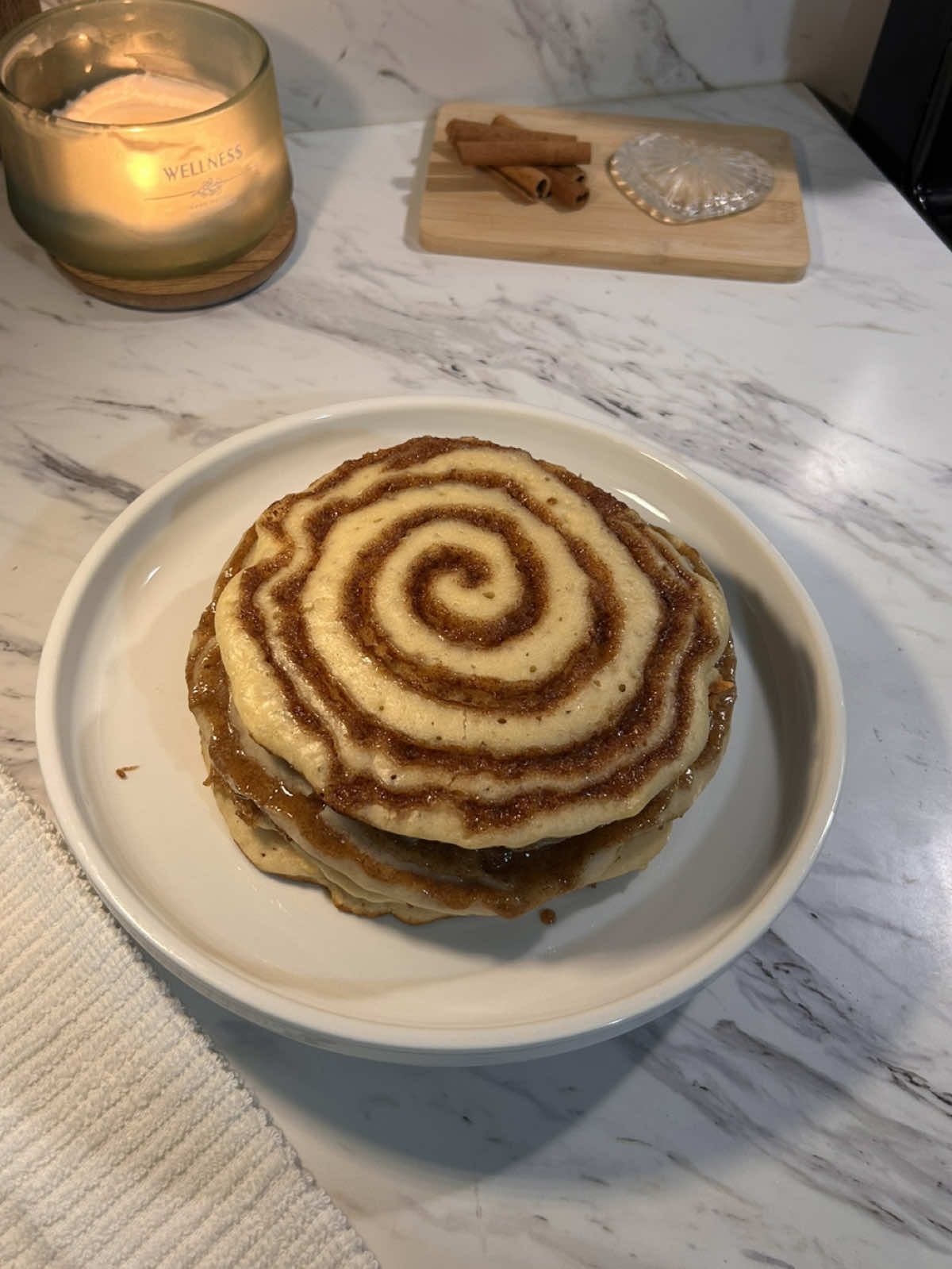 homemade fluffy buttermilk  cinnamon roll pancakes !! 🤎   easy recipe:   	1 ½ cups flour(190g) 	2 tbsp sugar(25g) 	1 tsp baking powder 	½ tsp baking soda 	½ tsp salt 	1 large egg 	1 ¼ cups buttermilk (300ml) 	2 tbsp melted butter(30g) (plus more for cooking) 	1 tsp vanilla extract   in a bowl, whisk flour, sugar, baking powder, baking soda, salt. In another bowl, whisk egg, buttermilk, melted butter, and vanilla. stir wet into dry gently — batter should be a little lumpy (don’t overmix). rest batter 5 minutes while you prep the swirl.   heat a pan over low to medium-low. pour about ¼ cup of batter for each pancake and let it spread slightly. pipe the cinnamon swirl on top, then cover the pan with a lid. let the pancake steam for 4-5 minutes, keeping the heat low so the bottom doesn’t burn. ( DONT FLIP ) once the top looks set and the edges are cooked through, carefully lift it out and drizzle with glaze. ( DONT TOUCH THE SUGAR AT ALL )     cinnamon swirl:   ¼ cup butter (55 g), melted ½ cup brown sugar (100 g), packed 2 ½ tbsp all-purpose flour (20 g) 2 tsp cinnamon mix until smooth and thick but still pipeable. If it feels too stiff → add 1–2 tsp melted butter or milk to loosen. If it feels too runny → sift in another ½ tbsp flour. ( or just refrigerate it but it’ll get hard so be careful )   glaze:   ½ cup powdered sugar (60 g) 2 tbsp heavy cream (30 ml) ½ tsp vanilla extract whisk until smooth. If it’s too thick, add another splash of cream; if it’s too thin, sift in a bit more sugar.   #cinnamonroll #pancakes #Recipe #bakingrecipe #fyp 