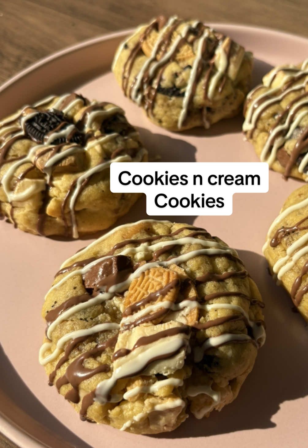 Makes 11 large cookies Ingredients: - 281g cake flour - 3/4 cup brown sugar - 1/4 cup white sugar - 1 teaspoon salt - 1 1/2 teaspoons cornflour - 1 teaspoon baking soda - 1 large egg - 170g melted butter - 1 teaspoon vanilla essence - 16 Oreos (your choice of flavor) - 2 slabs of white chocolate - 1 slab of brown chocolate - 1 slab of white chocolate melted (optional for garnish) Instructions: 1. Combine the melted butter and sugars in a bowl and whisk well. 2. Add the vanilla essence and egg and whisk again. 3. In a separate bowl, whisk together the baking soda, cornflour, and salt. 4. Gradually add the dry ingredients to the wet ingredients, mixing until just combined. 5. Fold in the Oreos and chocolate pieces. 6. Use an icing scoop to form the mixture into balls and place them on a baking sheet lined with parchment paper. 7. Freeze the cookies for at least 4 hours before baking. 8. Preheat your oven to 177 degrees Celsius and bake the cookies for 12-15minutes. 9. Allow the cookies to cool at room temperature before drizzling with melted white chocolate (optional). 10. Store the cookies in an airtight container at room temperature.  #cookies #whitechocolatecookies #fyppppppppppppppppppppppp #fyp #baking 