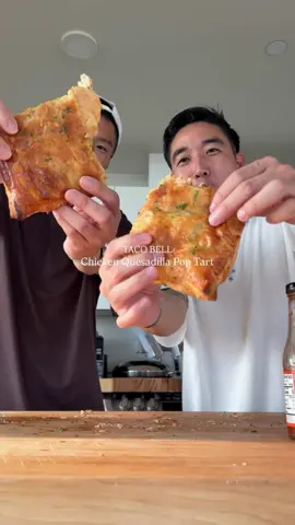 your boyfriend will cry if you make this Taco Bell Chicken Quesadilla Pop Tart with @saintyim  Each (4): 697 Calories | 53g Protein  Ingredients: 2 puff pastry sheets Egg wash 800g chicken breast Taco seasoning Cilantro for garnish Creamy Jalapeño Sauce: 150g Greek Yogurt 25g light mayo Chopped pickeledJalapeño- as much as you want 35-40g Jalapeno Juice 1/2 tsp Garlic Powder 1/2 tsp onion powder  1/2 tsp chili powder 1 tsp tsp Cumin 3 pinch of salt Oven @ 400° for 10-12 mins #tacobell #chicken #quesadilla #cheese 