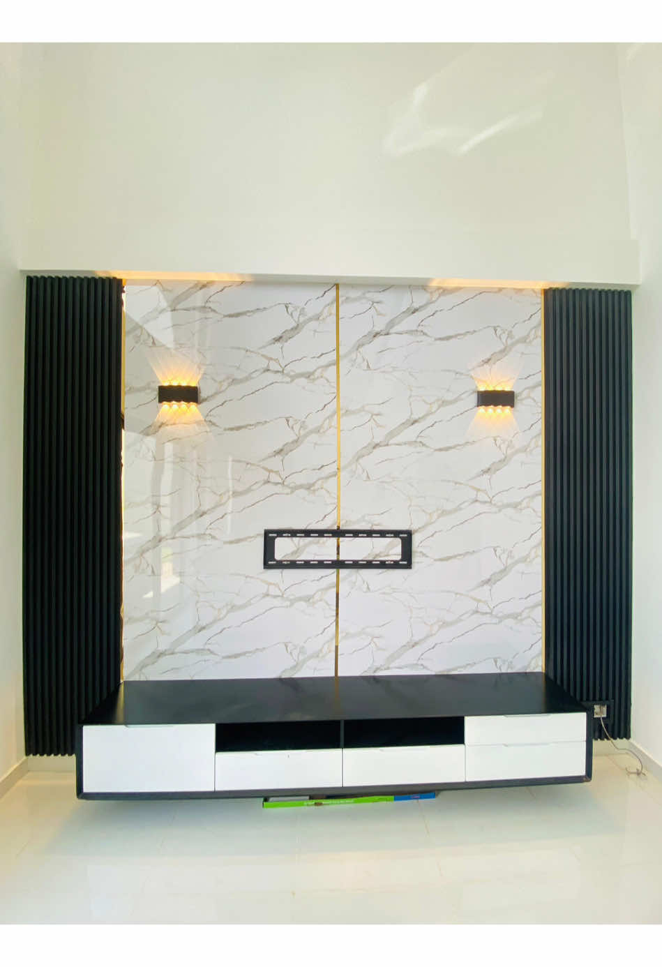 Executed with precision by Empire Deco – a TV backdrop finished in fluted wall panels and marble sheet. Contact us +94 70 799 2000 #flutedpanel #Home #interiordesign #srilanka #tvwall 