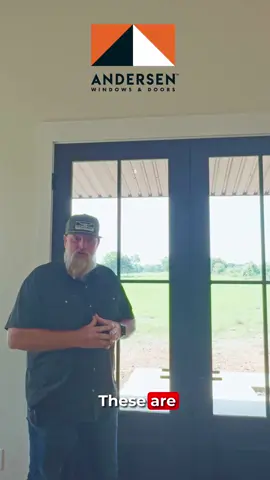 Stepping inside, and the first thing you see? These gorgeous Andersen E‑Series double doors. They’re aluminum‑clad, wood‑framed, with a matching grid pattern that ties in perfectly with all the windows. And because it’s an 8‑foot door, it comes with a three‑latch locking system — sturdy, secure, and sleek. We kept the look clean by staining them to match the black theme carried throughout the home with our 100‑series windows. And just around the corner? An Andersen A‑Series sliding door that’s just as stunning. Smooth glide, beautiful lines, and a perfect match for the space. Andersen really nailed it with these designs — style + function = perfection. 🖤 #AndersenWindows #AndersenDoors #BarndominiumLiving #CustomHomeDesign #TexasBestConstruction #HomeInspo #ModernFarmhouse #SlidingDoor #DoubleDoors #HomeDetails #InteriorDesign #BlackWindows #DoorDesign #TexasHomes #BarndoLife