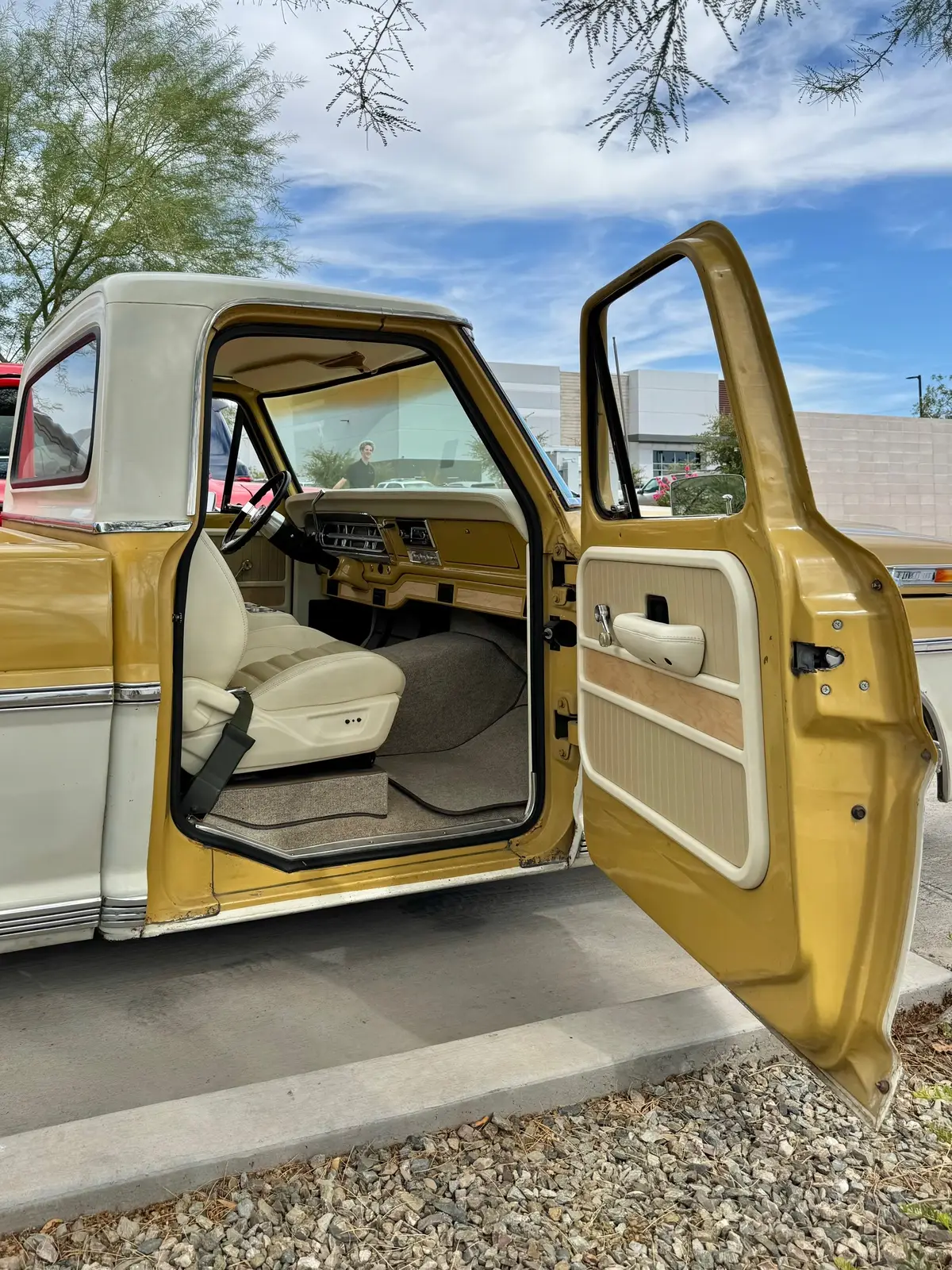 Almost wrapped up on interior for this ‘72 bumpside Revival build. This truck is super good looking, and now its clean and bright inside and out. Mustang bucket seats with a custom center console that’s got cup holders and storage, plus we threw in some wood accents on our new AC Valance (coming soon) and door panels. Kick panels, square weave carpet, and our Sparc garage series steering wheel tie it all together. All in this beautiful bone colored Apex leather with tan inserts. Still need to finish up the seat belts and a few other details, but this bright interior really complements that two-tone paint.  #fatfendergarage #72f100 #bumpside #revivalseries #custominterior ​​​​​​​​​​​​​​​​