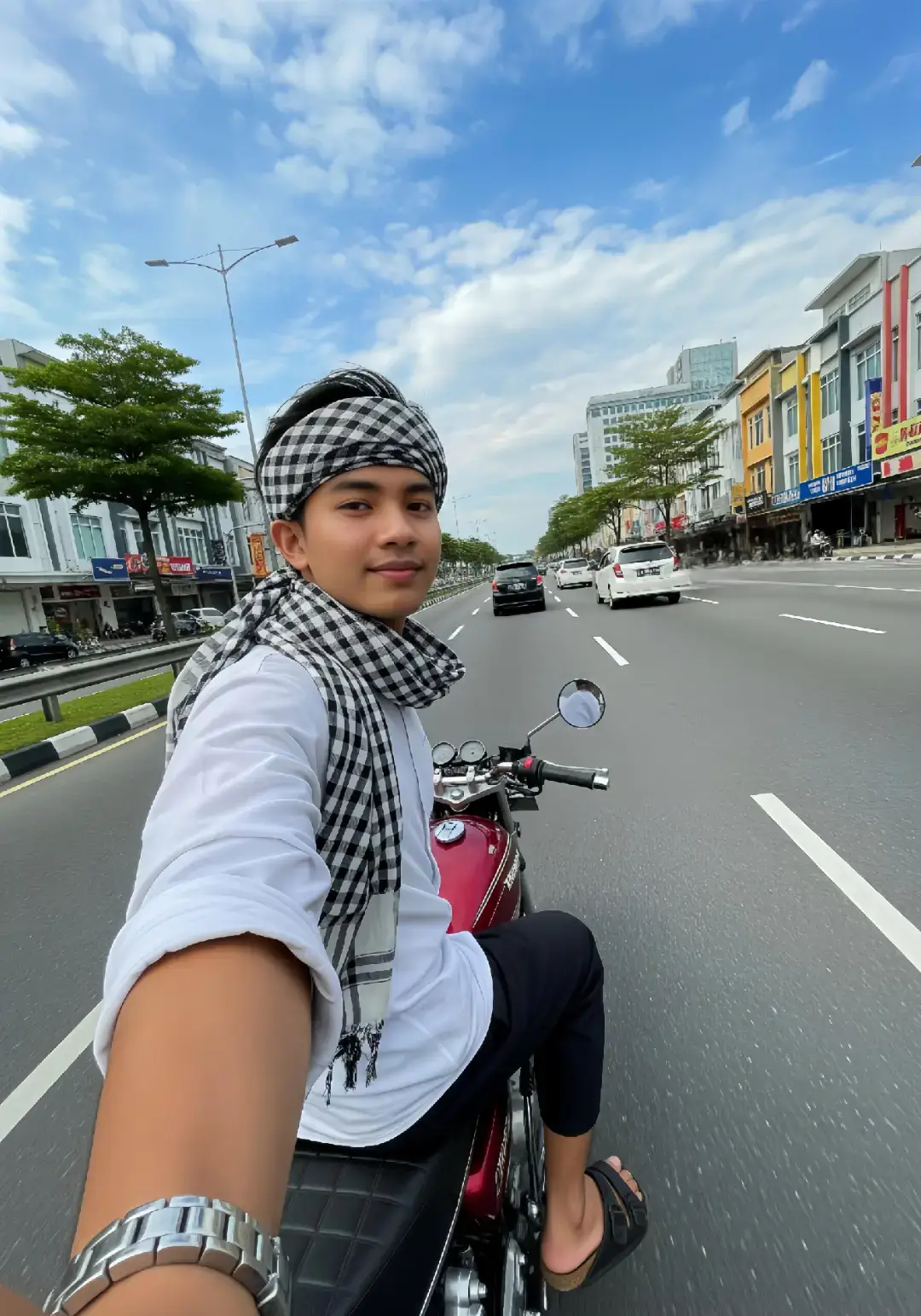 jum'atan bareng gemini pompt:👇🏻 . . . . . ​. ​Prompt: ​Sebuah swafoto vertikal yang diambil dari sudut pandang rendah, memperlihatkan seorang pemuda Muslim berkulit sawo matang, diperkirakan berusia awal dua puluhan. Ia memiliki rambut hitam yang klimis dan rapi, dengan mata cokelat yang ramah dan senyum tipis di bibirnya. Pemuda ini mengenakan baju koko putih polos yang rapi dan sarung kotak-kotak berwarna hitam dan putih yang dililitkan di pinggangnya, serta sandal jepit. Ia juga melilitkan sorban dengan motif kotak-kotak yang sama di lehernya, memberikan sentuhan gaya unik pada penampilannya. Tangan kirinya menjulur ke depan memegang sebuah kotak putih kecil bertuliskan 