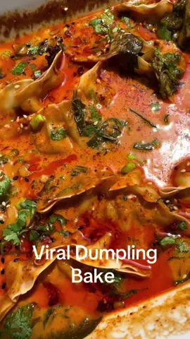 Viral Dumpling Bake with chili oil !  1. 12-14 frozen dumplings - I used @bibigo USA  2. 1 can full fat coconut milk  3. 2-3 tablespoons Thai curry paste  4. 3 tablespoons soy sauce  5. 1 tablespoon sesame oil  6. 1 tablespoon rice vinegar  7. 1 tablespoon ginger grated  8. 1 tablespoon garlic minced (4-5) cloves  9. 1 tablespoon honey  10. 1 cup of greens, spinach or bok choy  Garnish:  1. Chili oil or chili crisp  2. Scallions (green onion) sliced  3. Sesame seeds  4. Chopped cilantro  1. In oven safe baked dish spray with oven spray.  2. Add one can of coconut milk, soy sauce, Thai curry paste, sesame oil, ginger, garlic, honey.  3. Mix it.  4. Add in your greens and mix it again.  5. Adding your dumplings coat with some of the coconut milk.  6. Cover with foil and bake at 400° for about 20 minutes if you would like the sauce thicker you can add another few minutes.  7. Remove from the oven.  8. Top with any garnish as you like chili oil or chili crisp , green onions, sesame seeds, cilantro.  9. Eat as an appetizer or as a main dish with noodles or rice.  #food #Recipe #cooking #dumplings #easy 