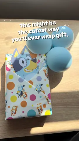 Gift wrap hack for Bluey fans! I used Bluey paper, folded it into pockets, slipped a laminated Bluey inside, and gave her little balloons to hold. Honestly, it turned into part of the present!🩵 #bluey #blueybirthday #giftsforkids #giftwrappingideas #toddlermum 